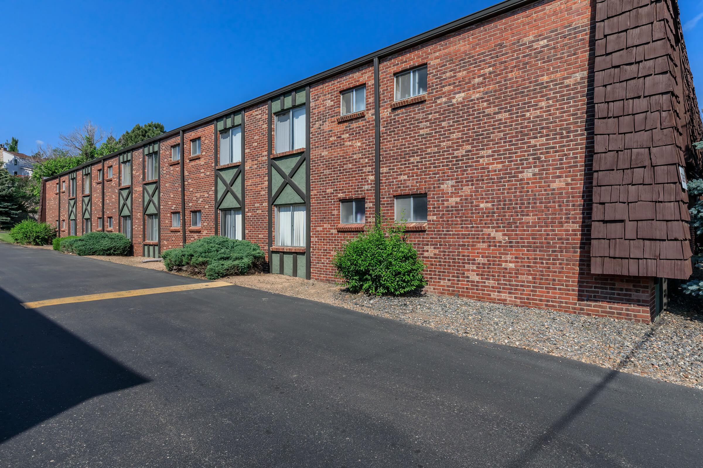 a tall brick building sitting on the side of a road