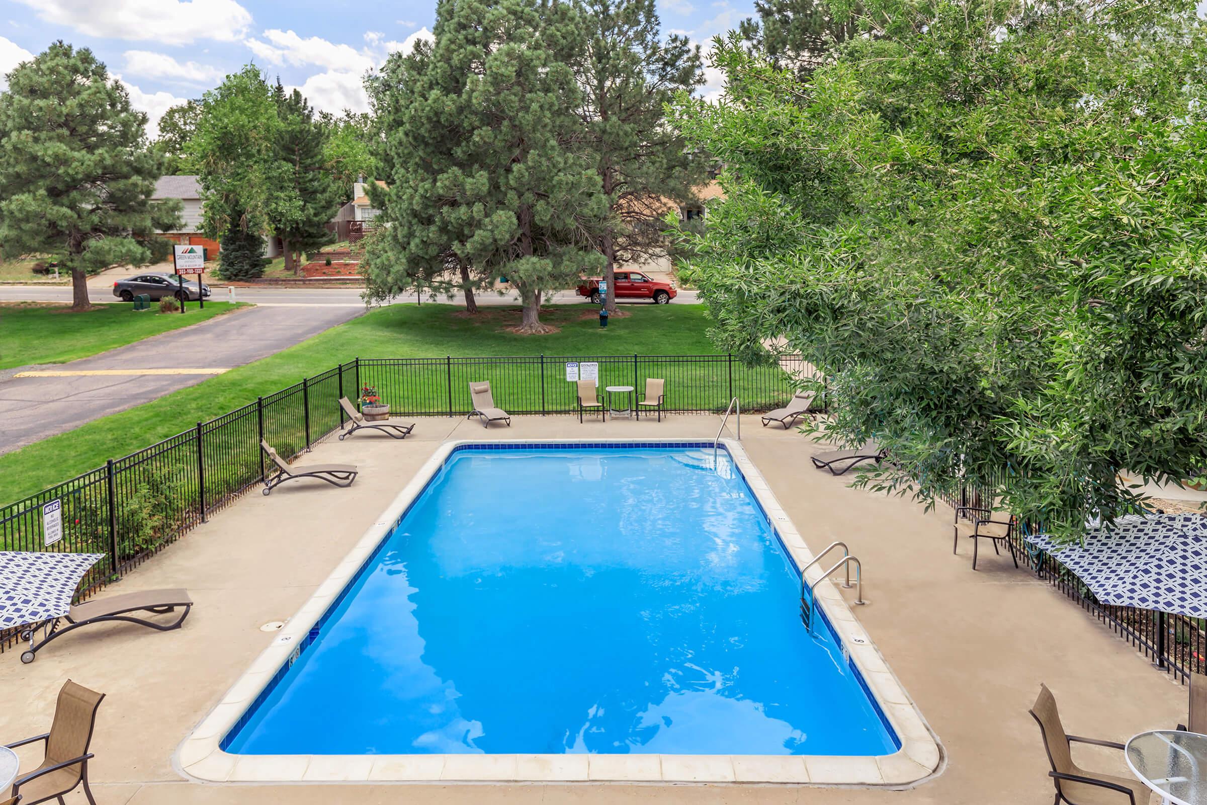 a group of lawn chairs sitting on top of a pool