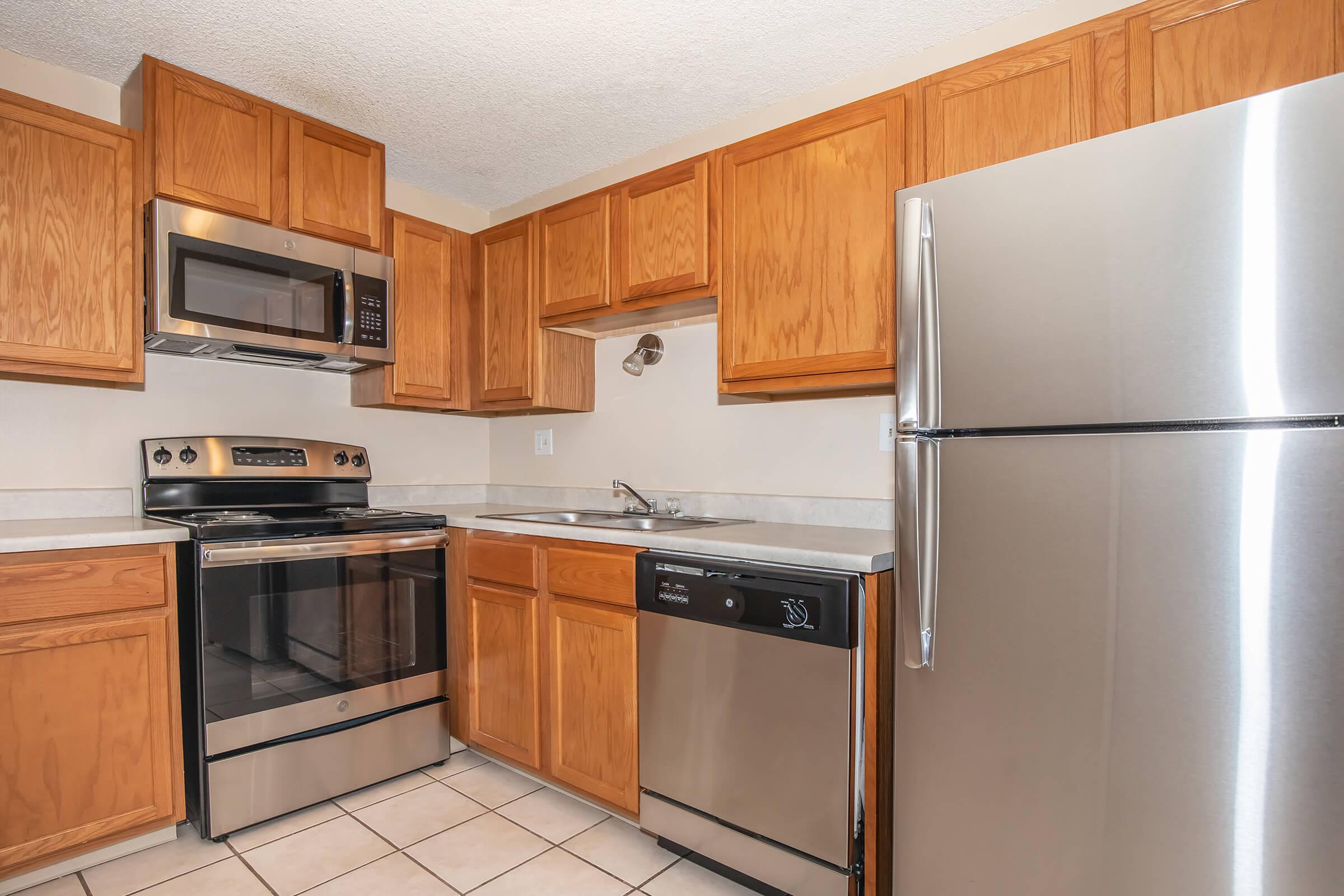 a kitchen with stainless steel appliances and wooden cabinets