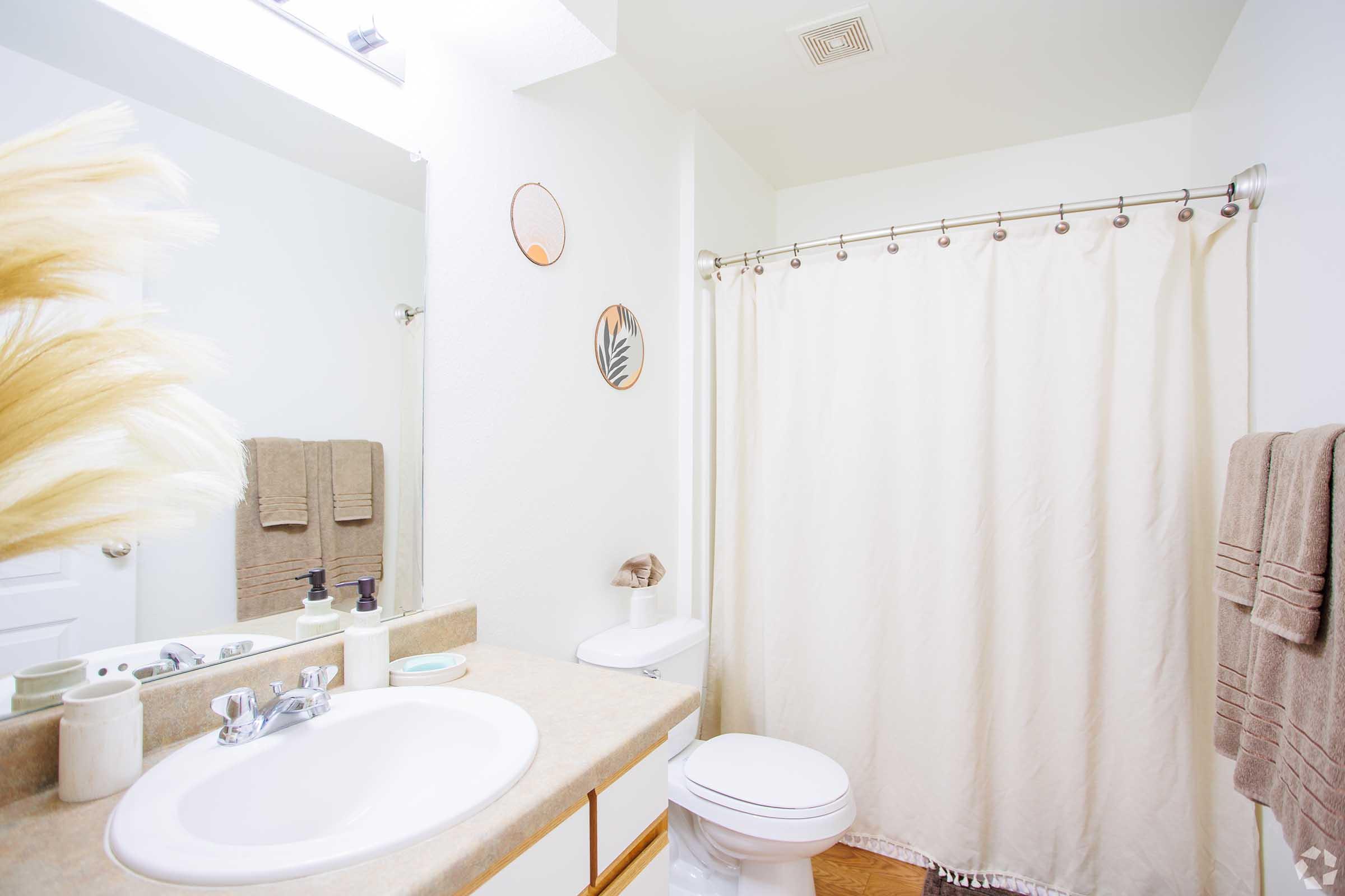 a shower curtain next to a sink