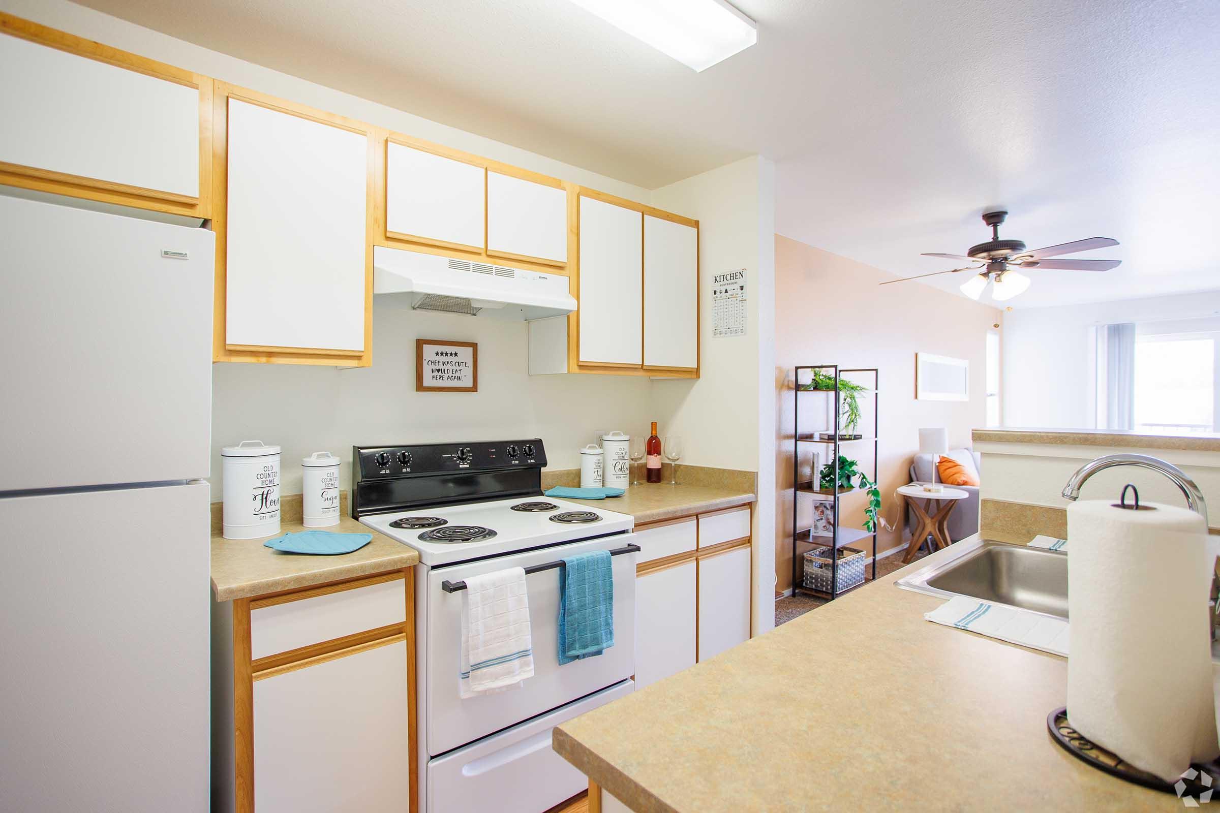 a kitchen with a refrigerator and table in a room