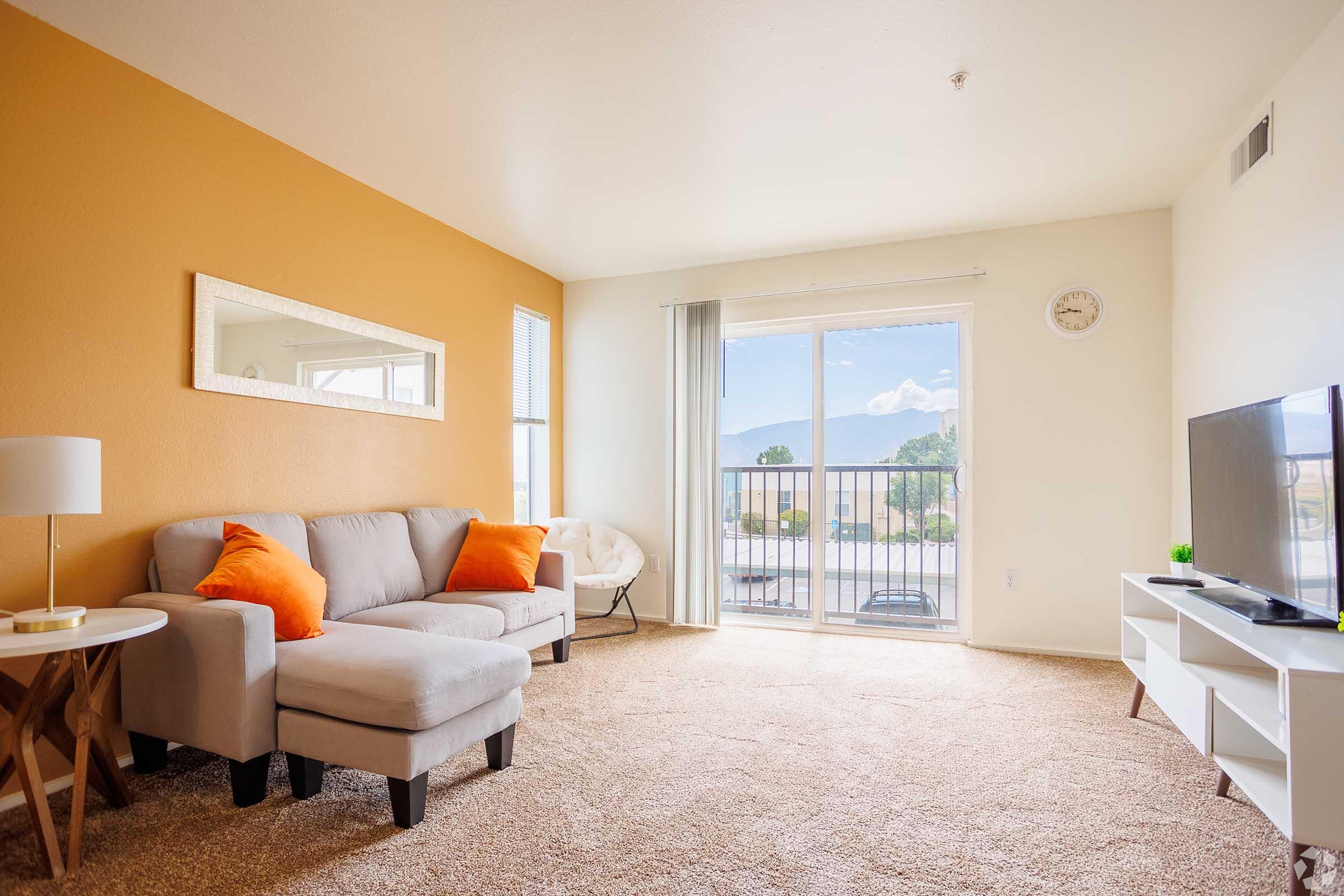 a living room filled with furniture and a flat screen tv