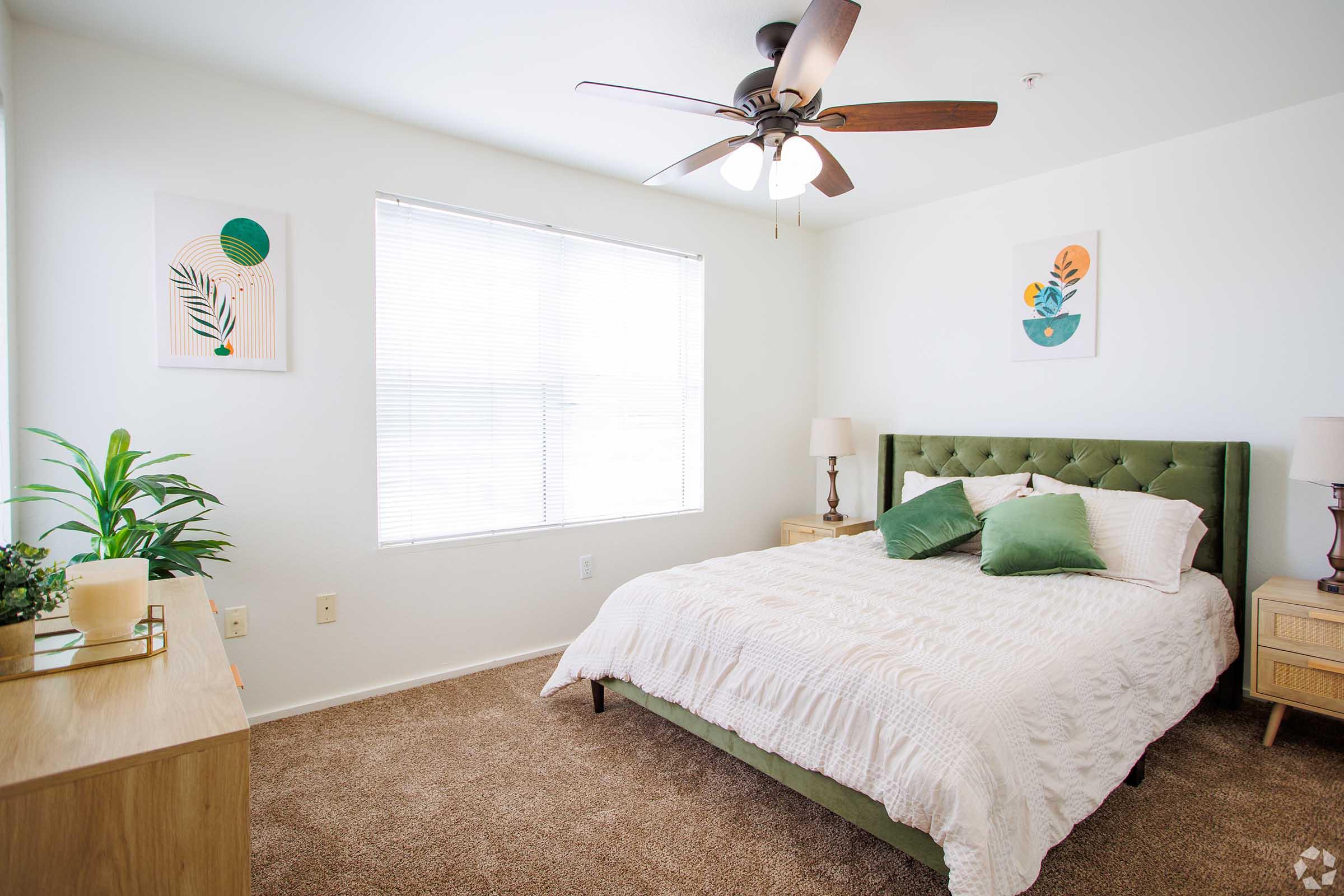 a bedroom with a bed and desk in a room