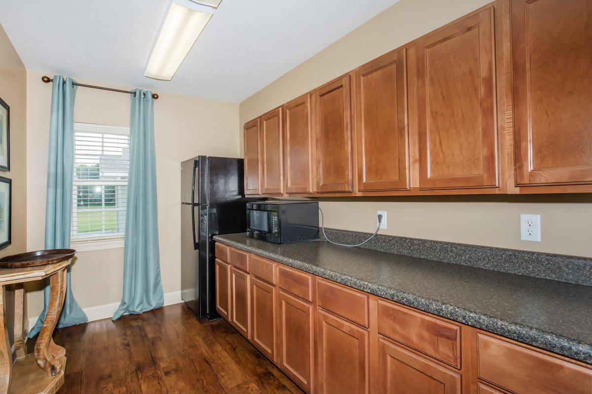 a kitchen with stainless steel appliances and wooden cabinets