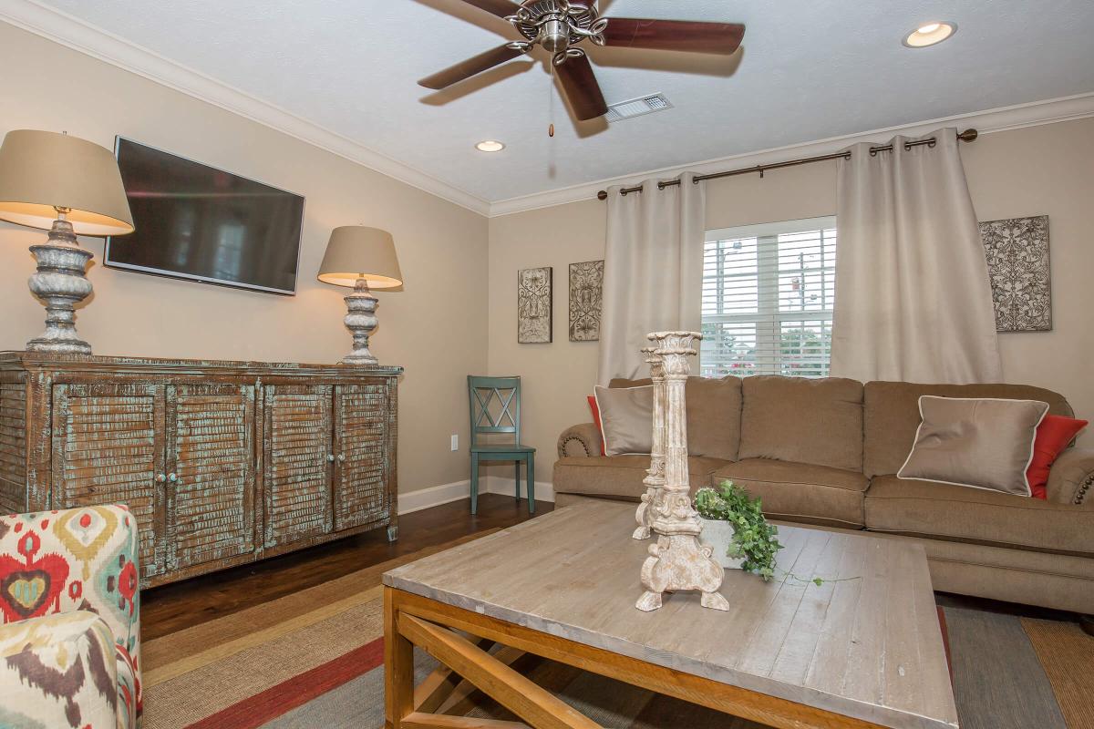 a living room filled with furniture and a large window