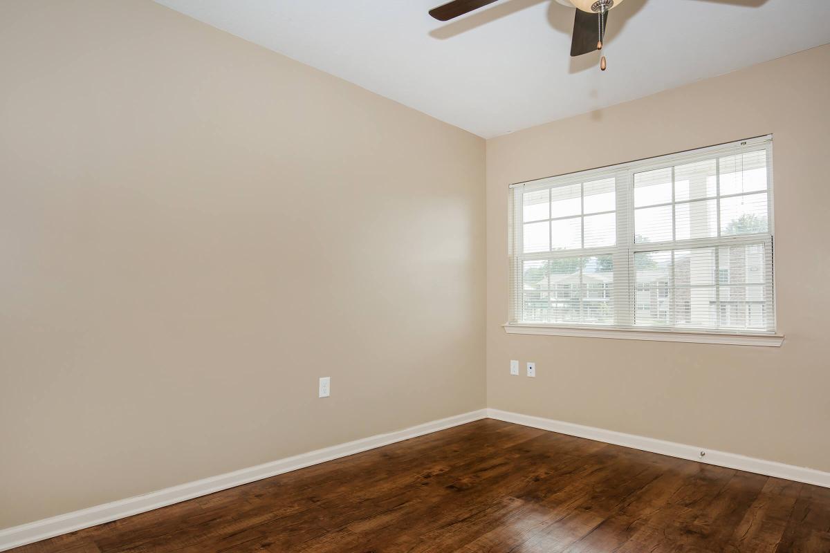 a large empty room with a sink and a window