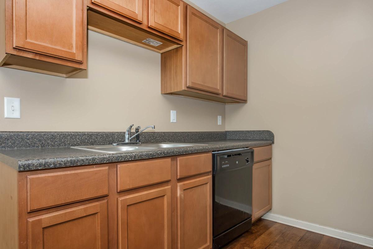 a kitchen with stainless steel appliances and wooden cabinets