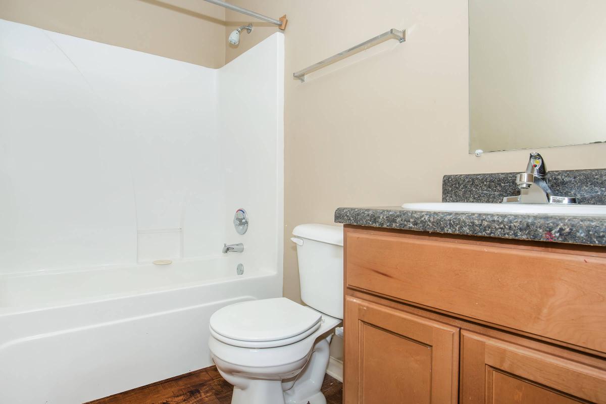 a white sink sitting next to a shower