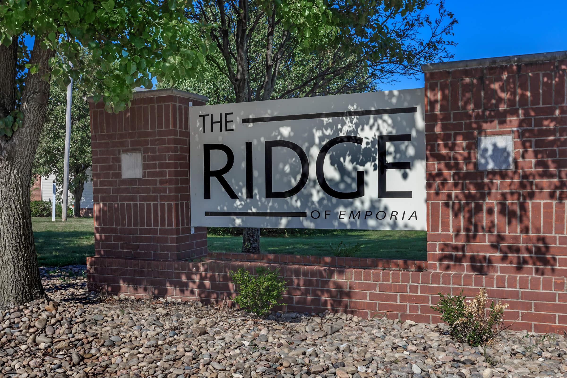 a sign in front of a brick building