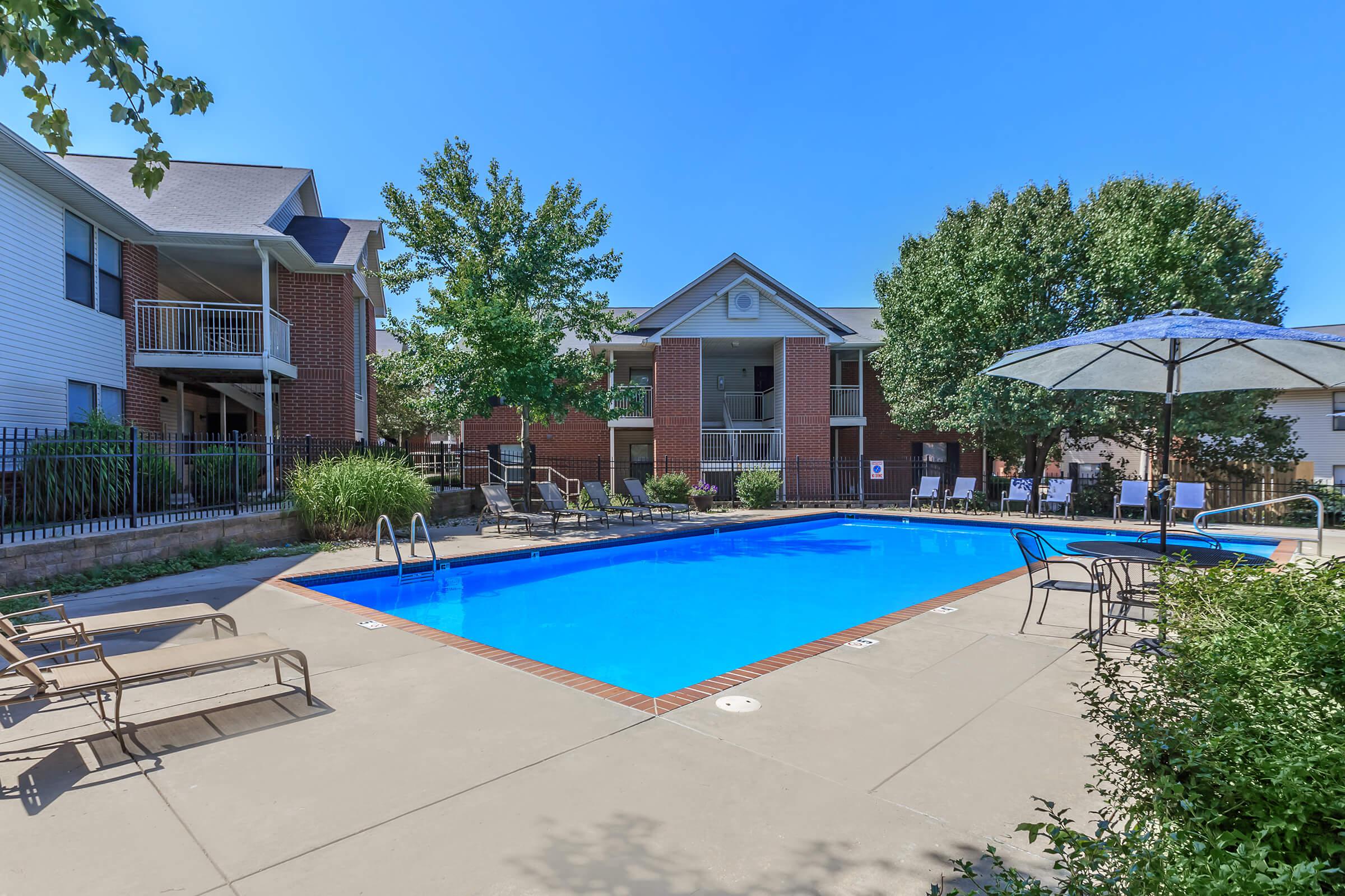 a house with a pool in front of a building