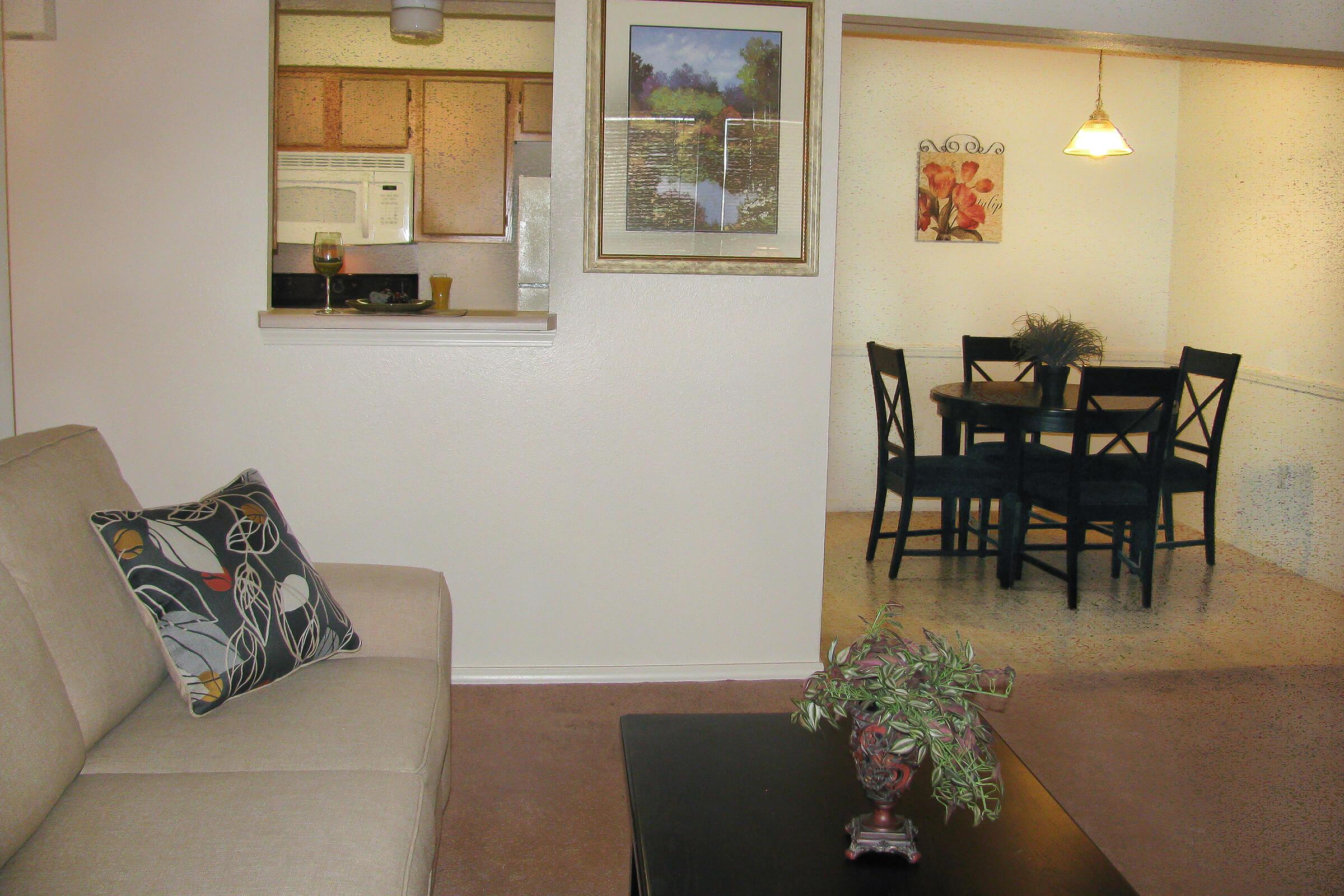 a living room filled with furniture and vase on a table