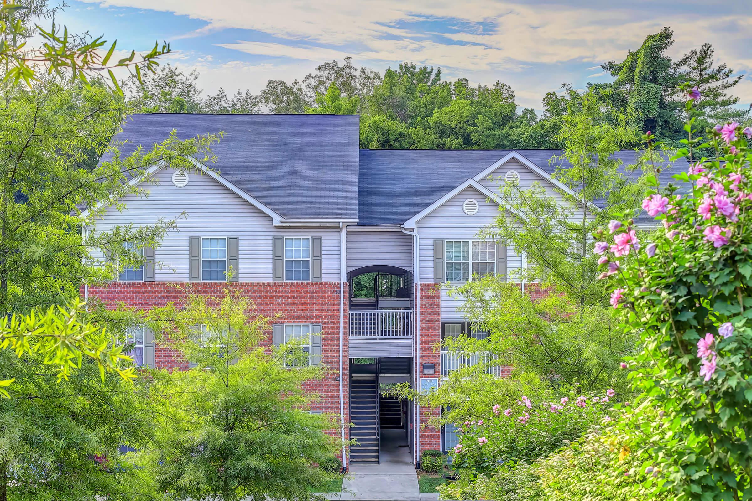 a house with bushes in front of a building