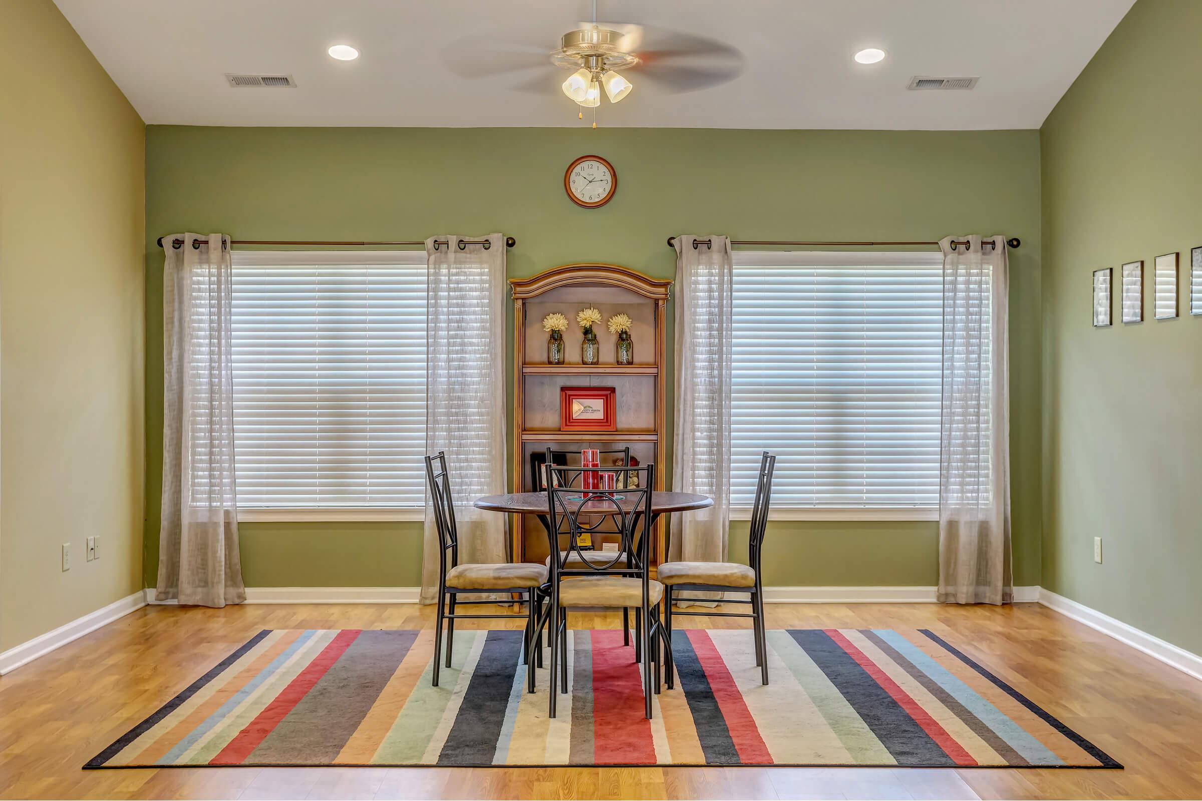 a living room filled with furniture and a large window