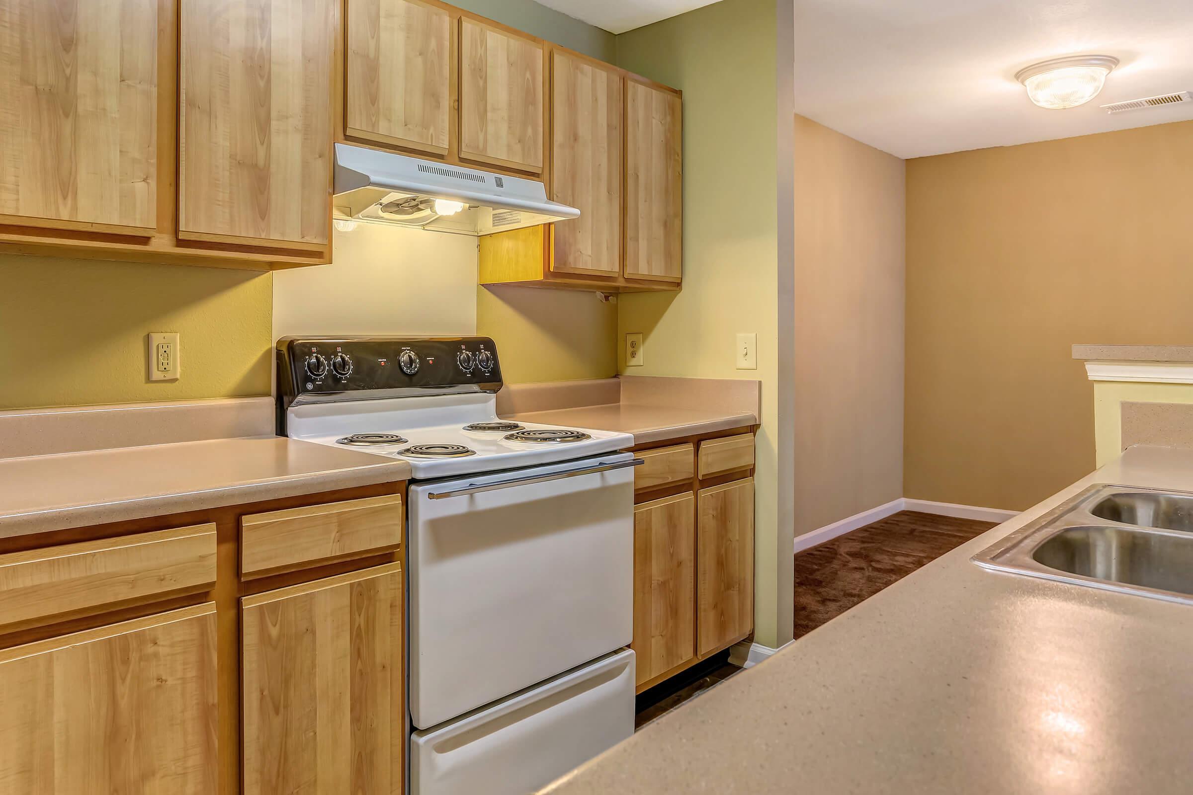 a kitchen with stainless steel appliances and wooden cabinets