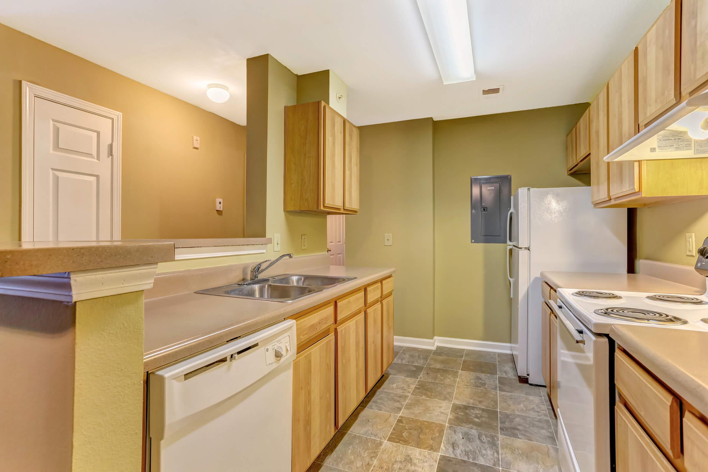 a kitchen with a sink and a refrigerator