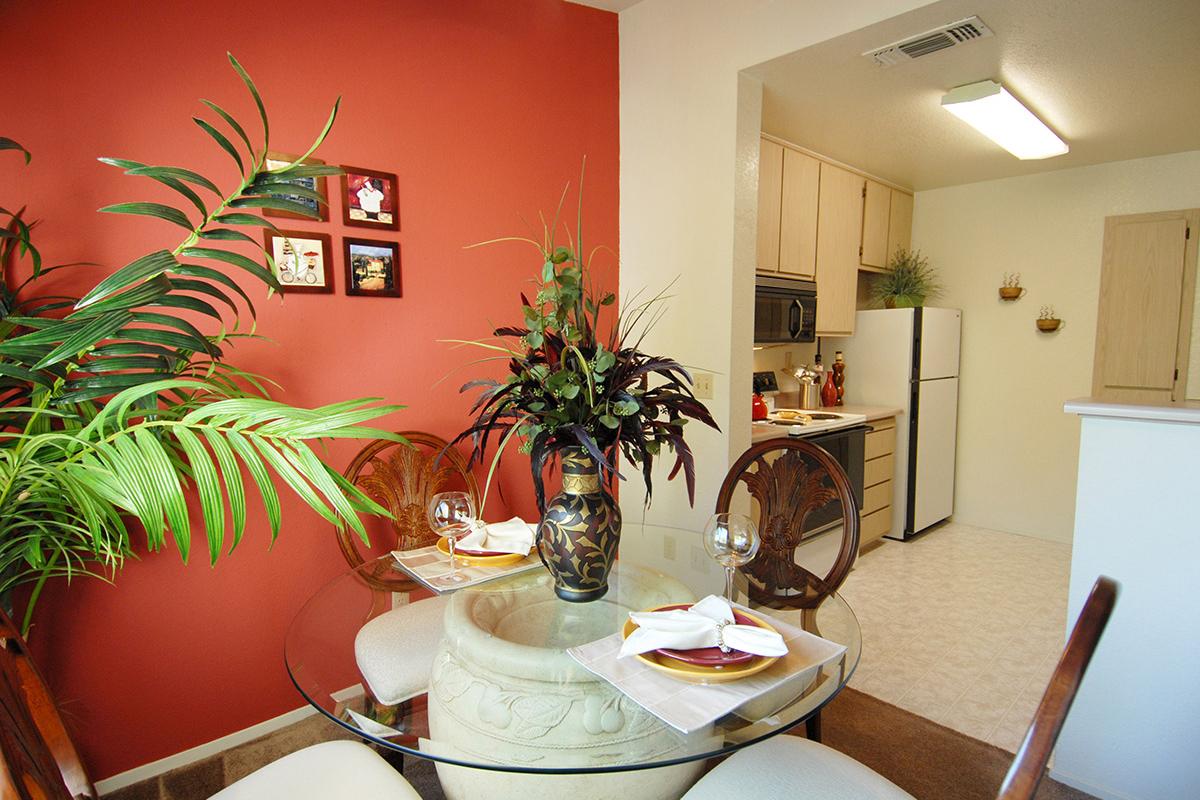 a living room filled with furniture and a plant