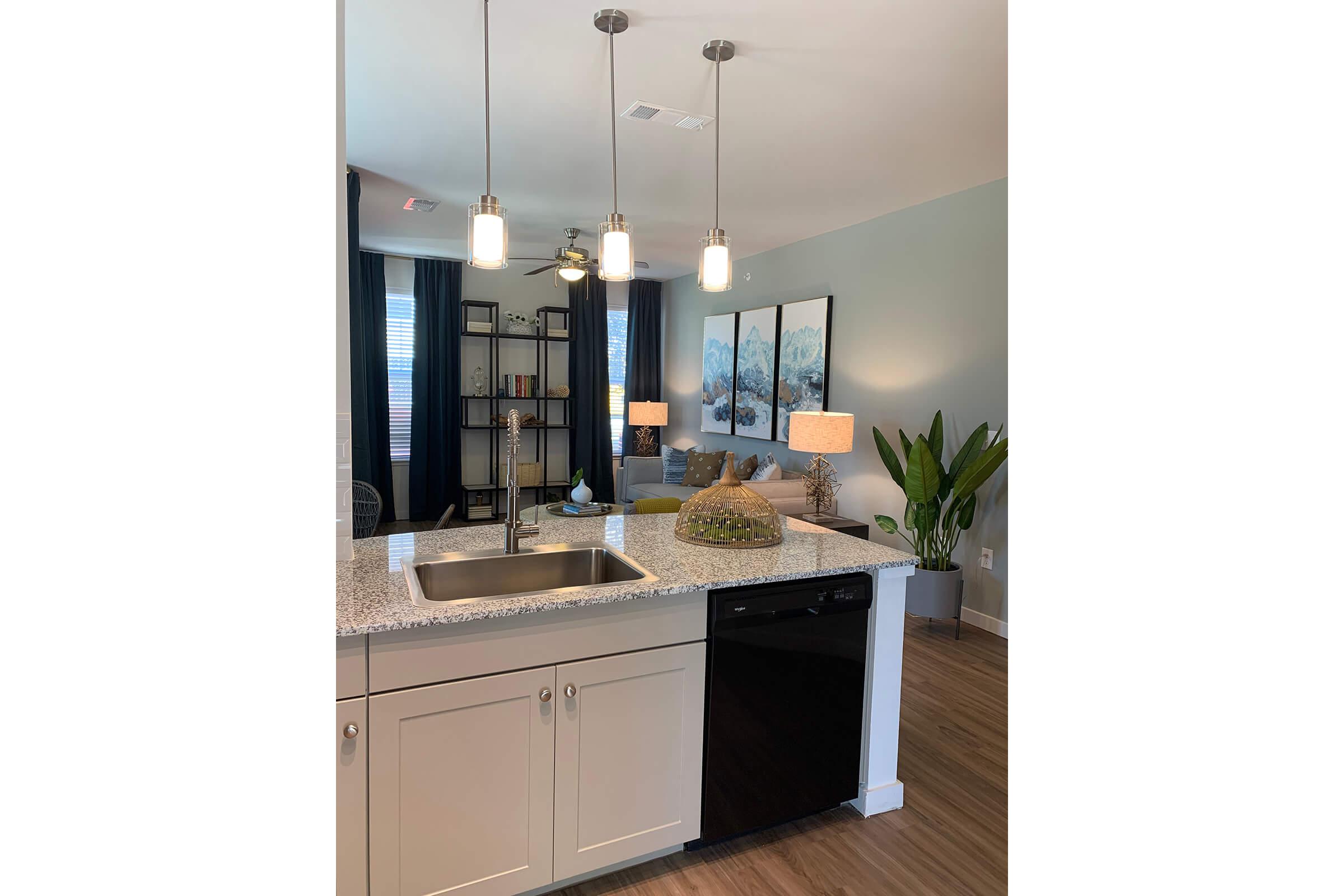 a kitchen with a sink and a mirror
