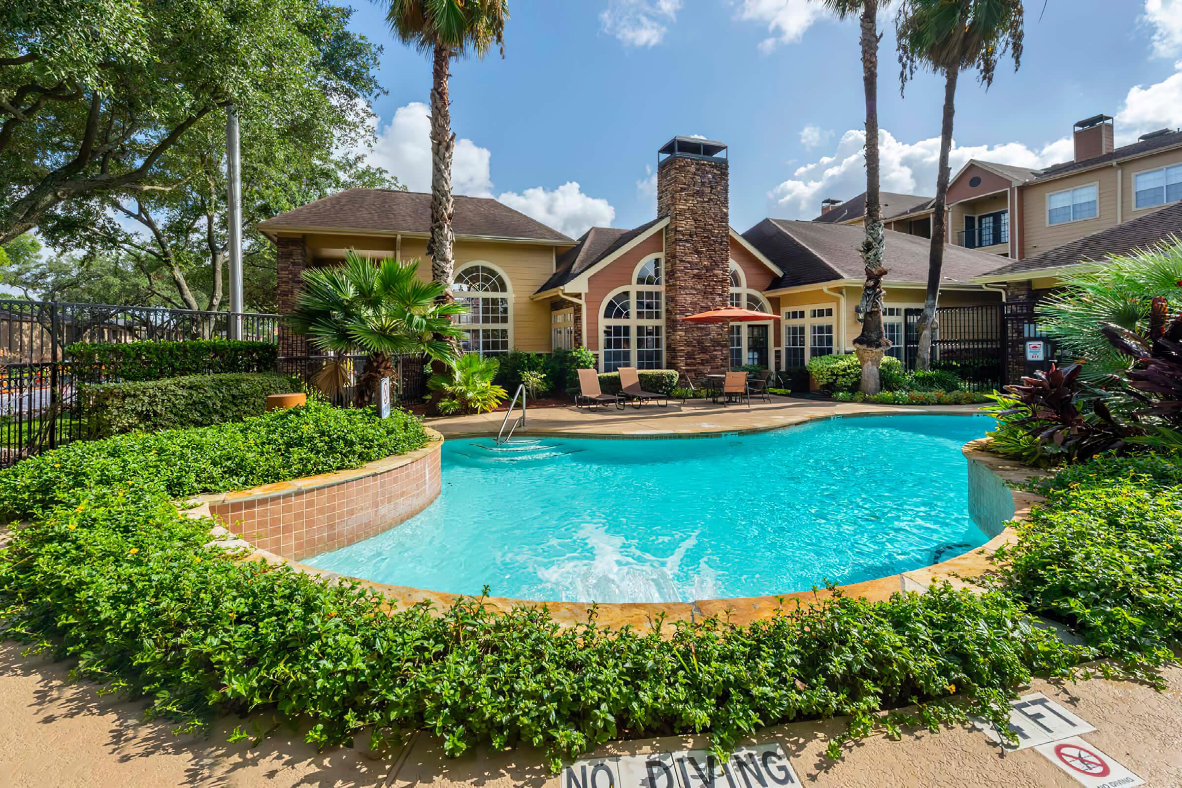 a house with a pool in front of a building