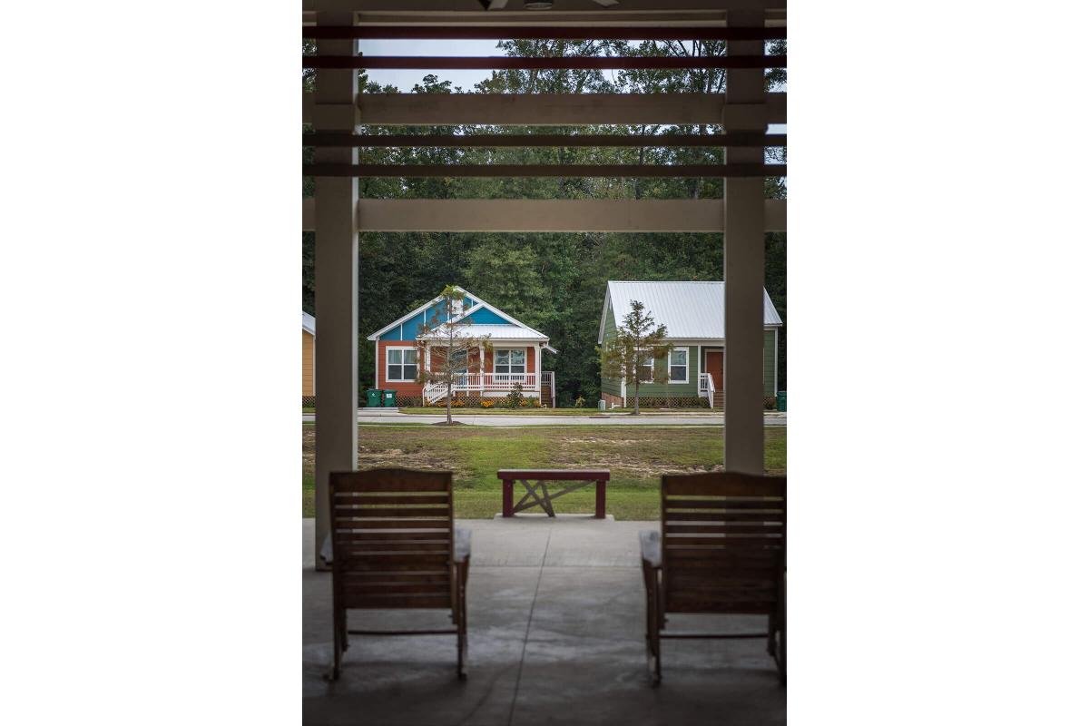 a wooden bench sitting in front of a building