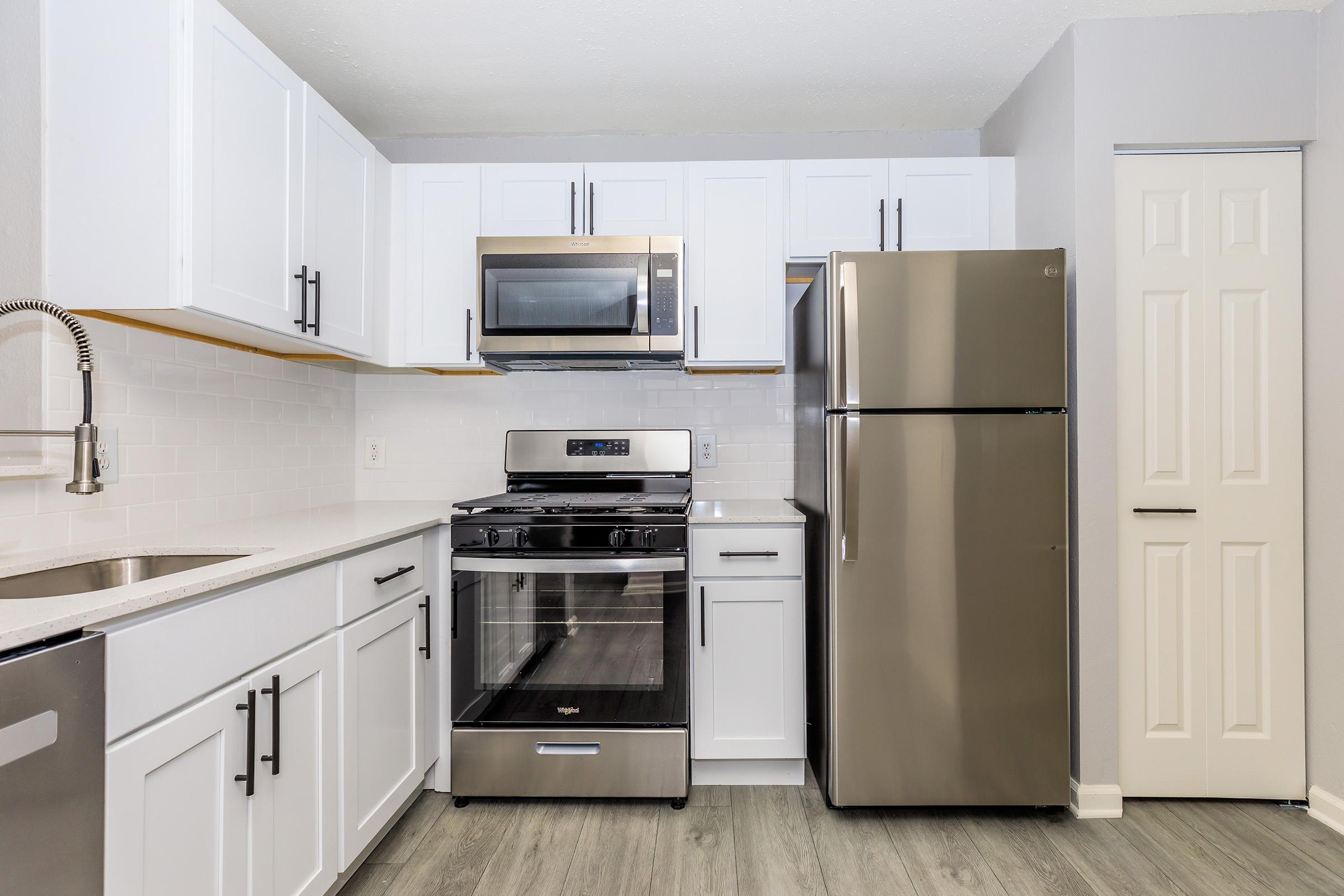 a kitchen with a stove and a refrigerator