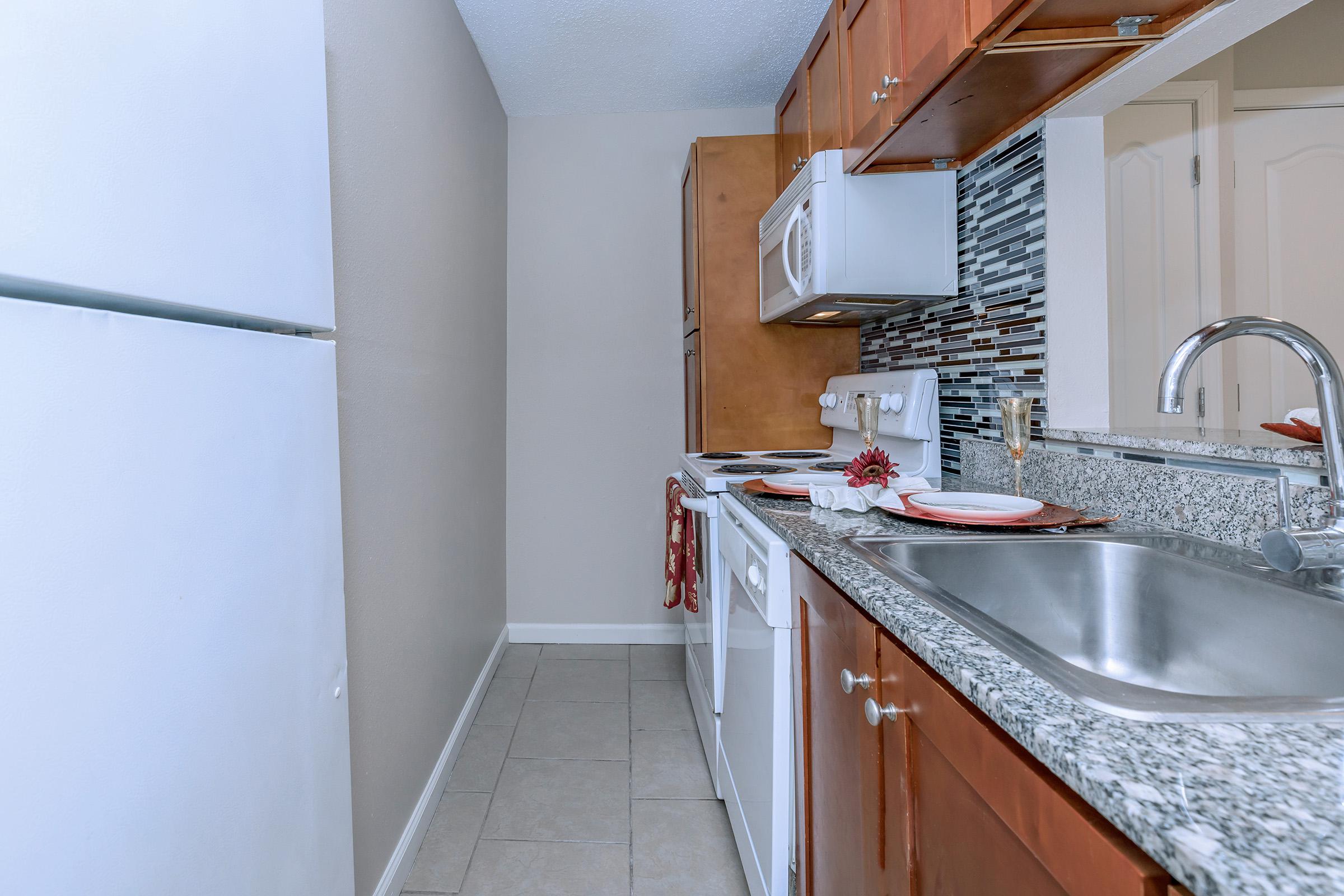 a kitchen with a stove and a sink