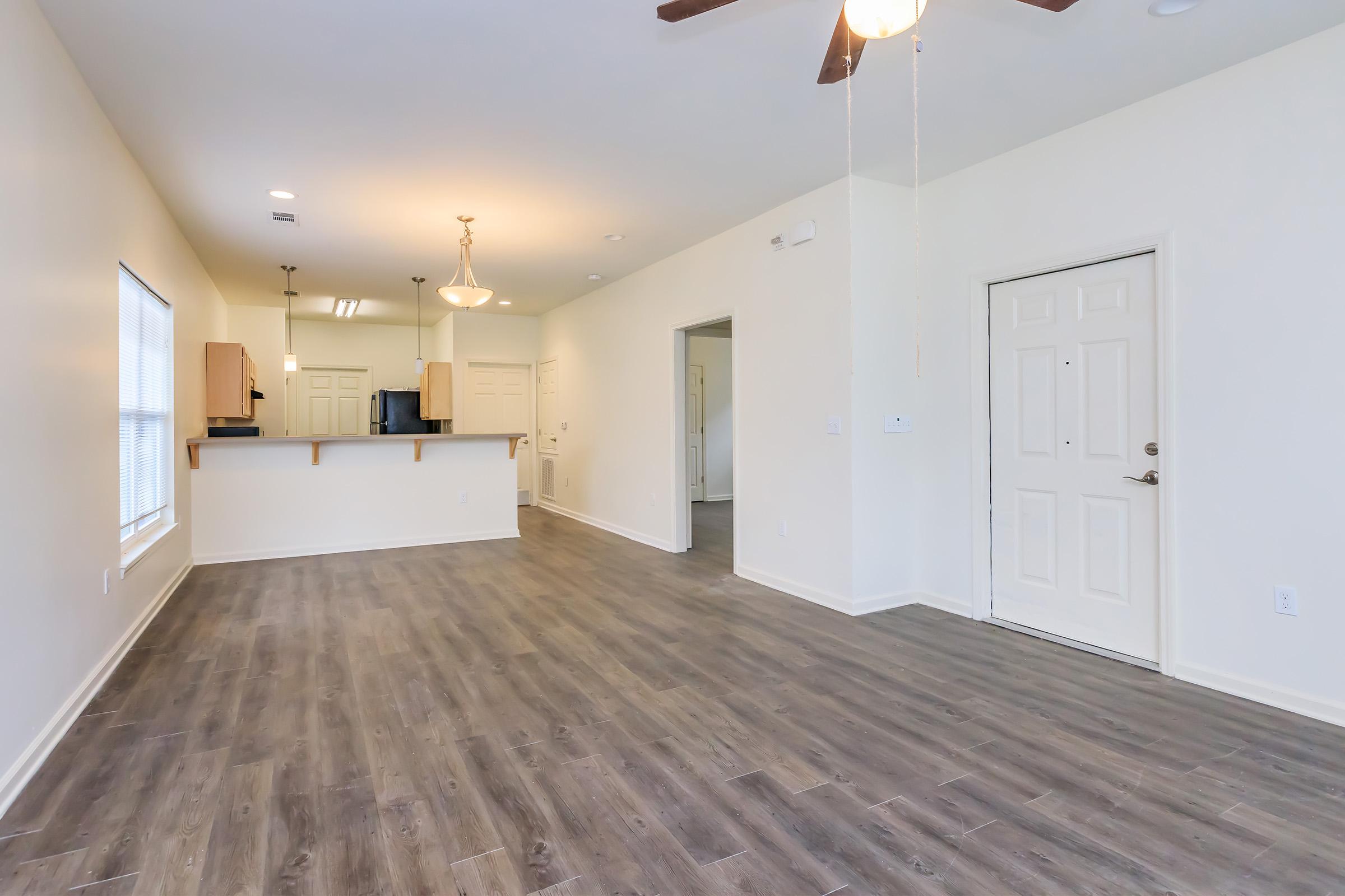 a large empty room with a wood floor