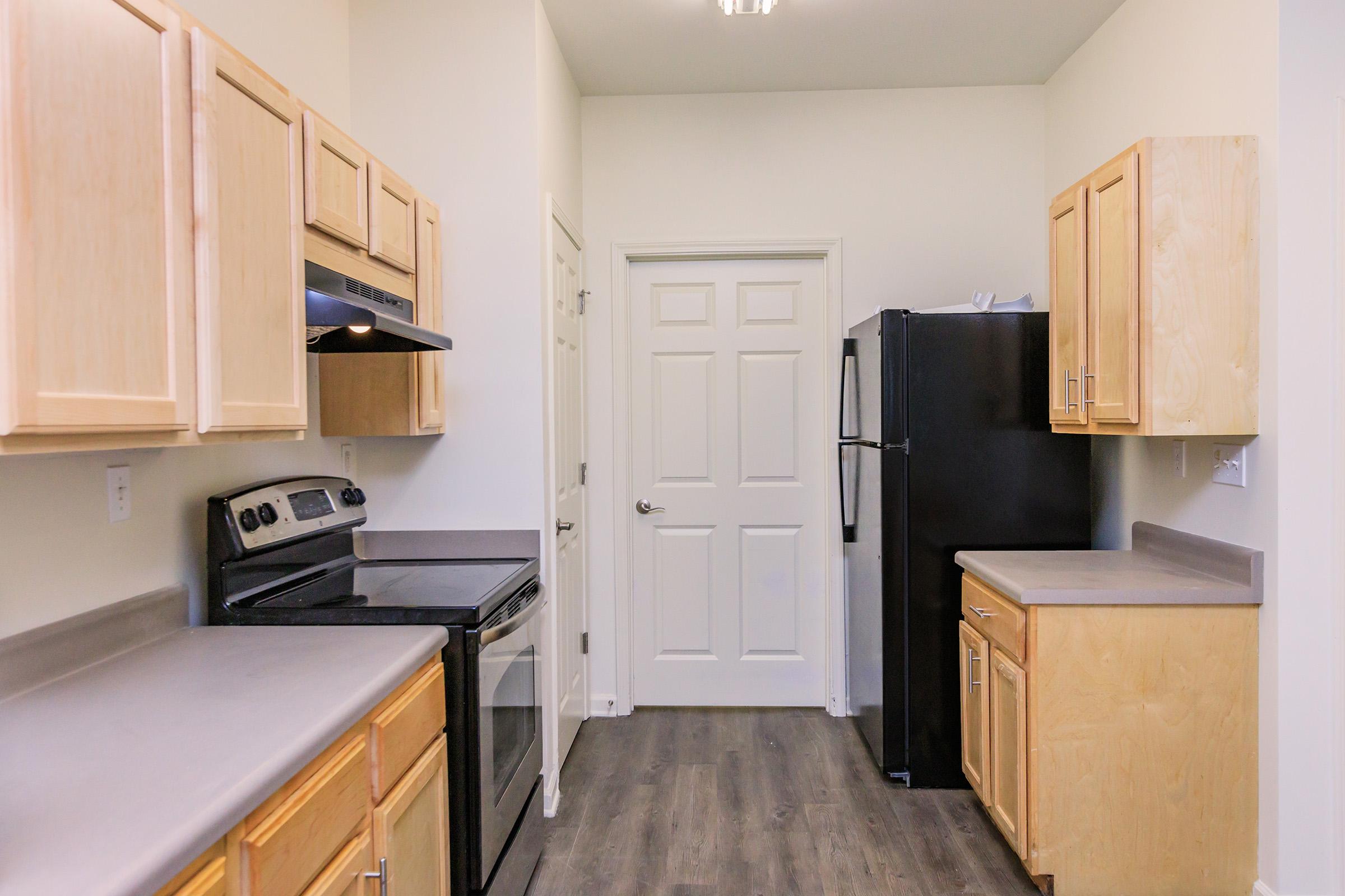 a kitchen with a stove and a refrigerator