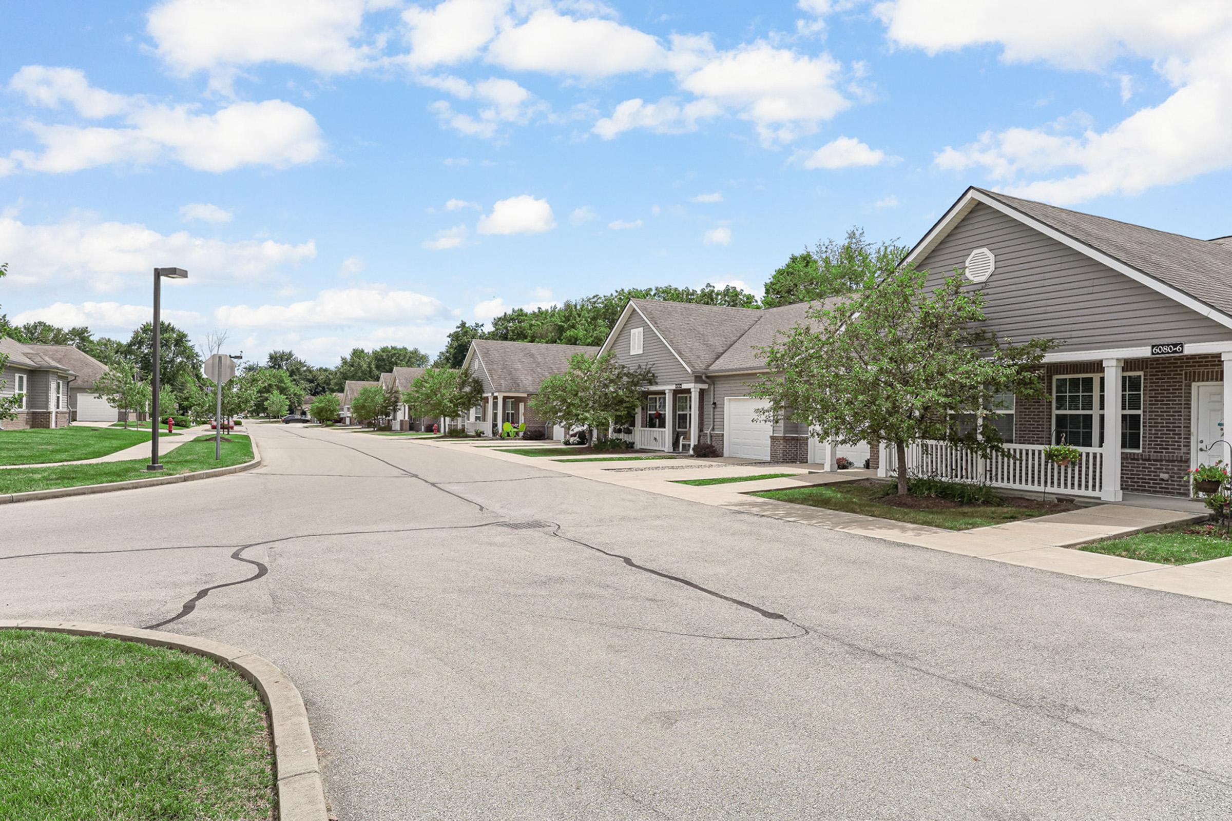 a dirt road in front of a house