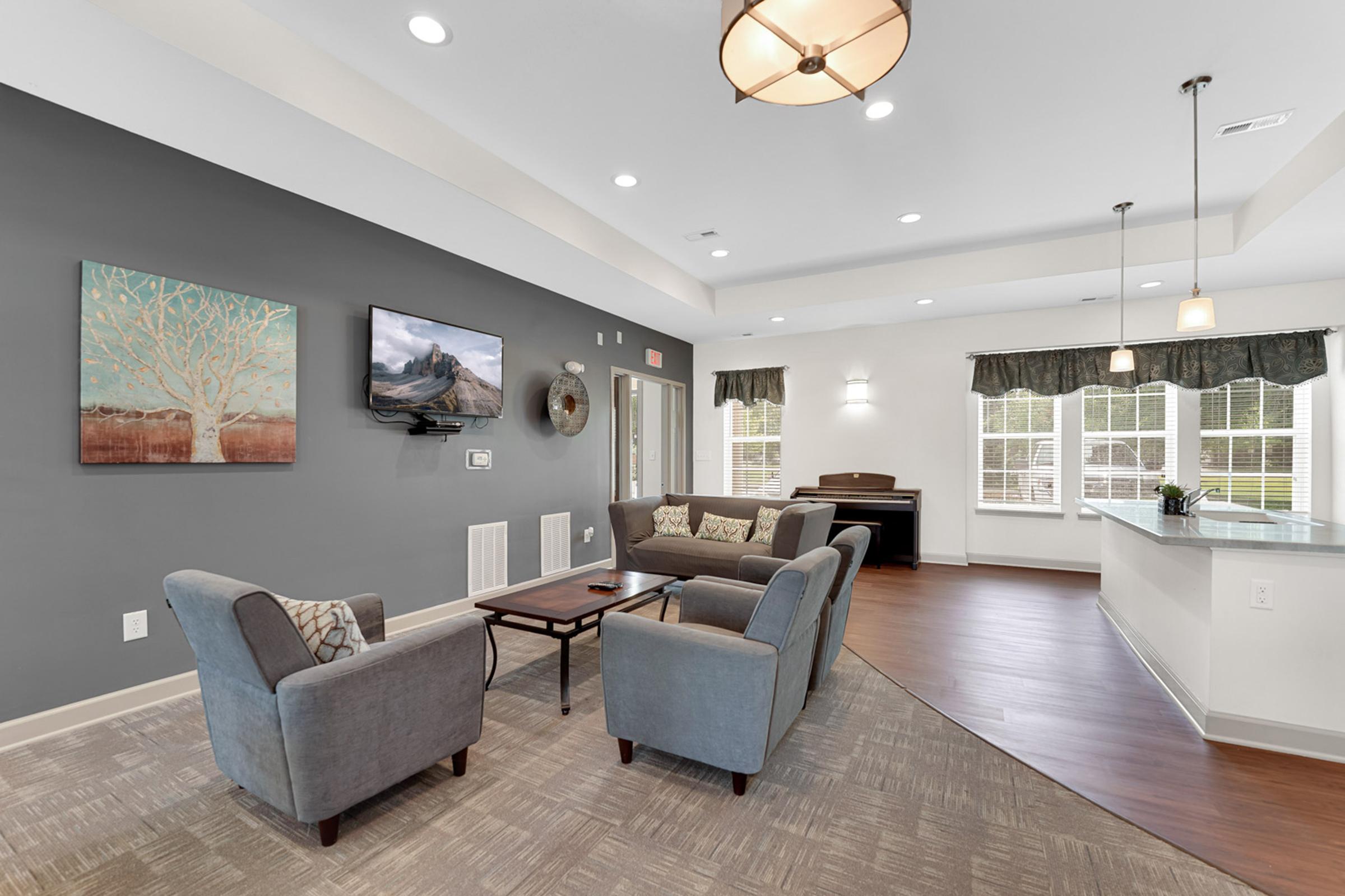 a living room filled with furniture and a large window