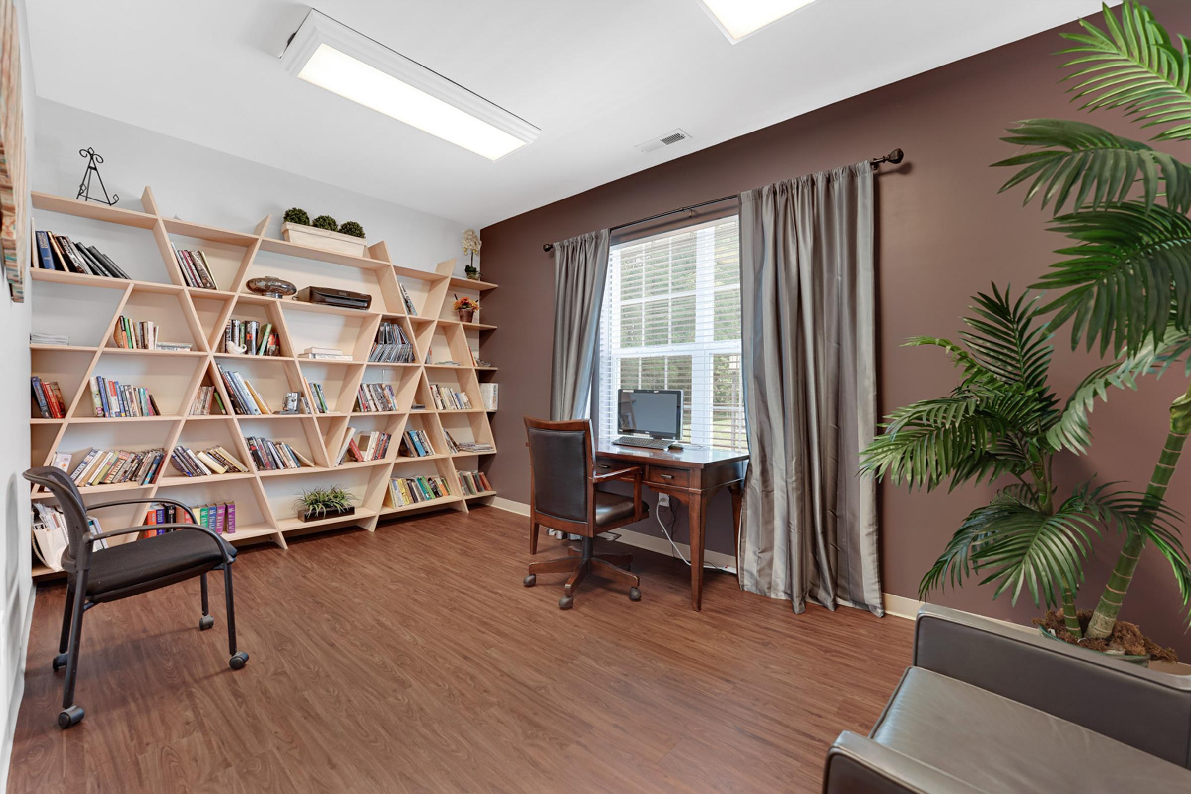 a living room filled with furniture and a large window