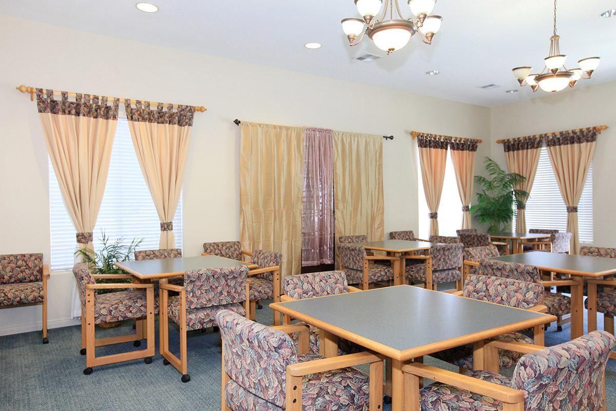 Harmony Terrace Senior Apartment Homes community room with tables and chairs