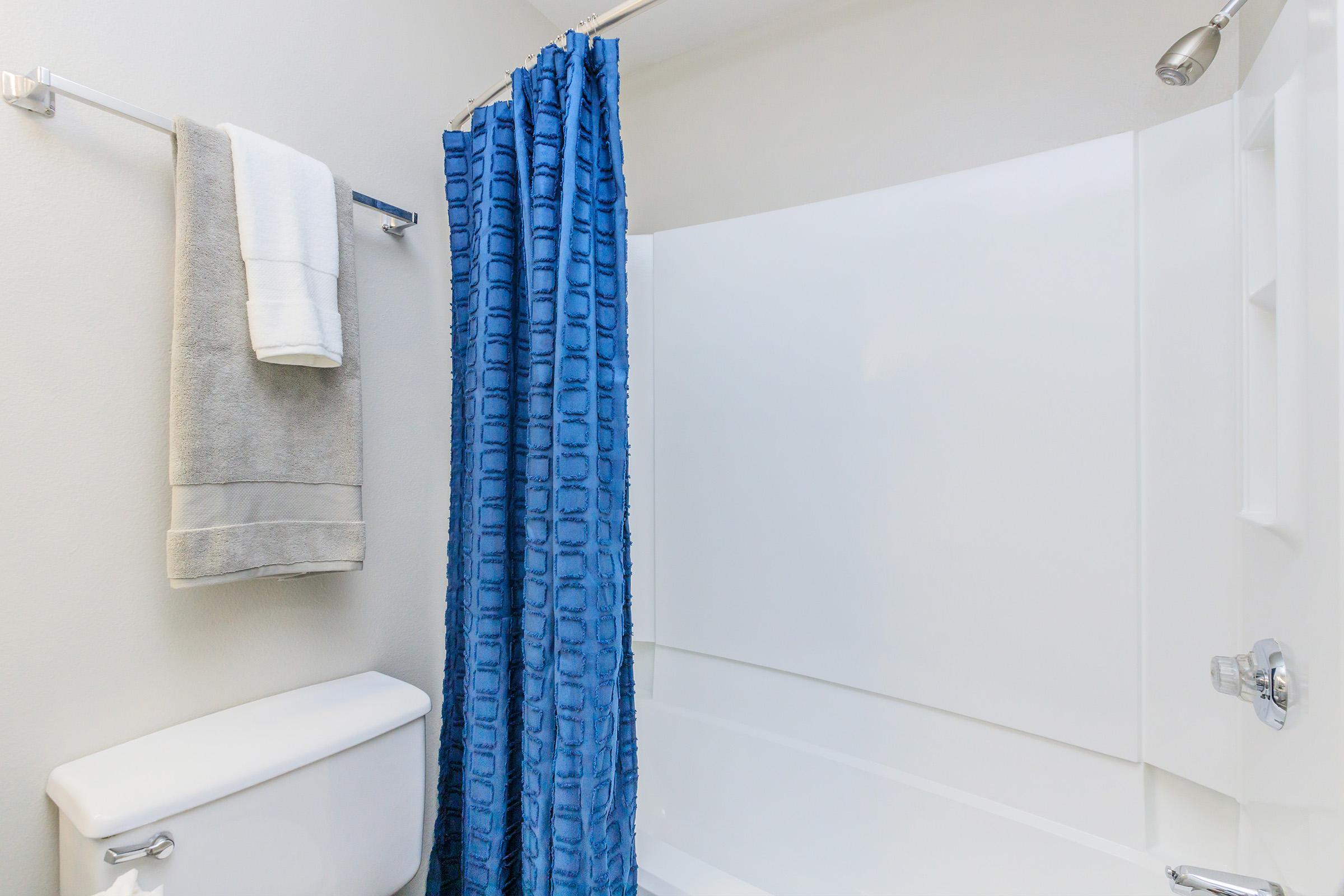a shower with a towel hanging on the wall