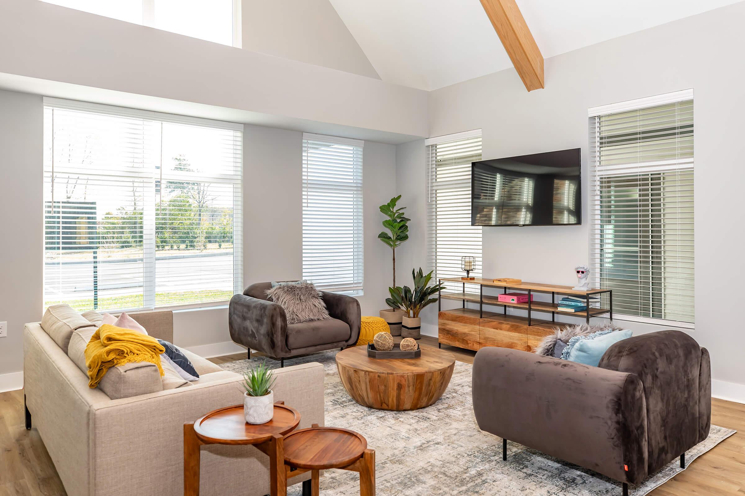 a living room filled with furniture and a large window