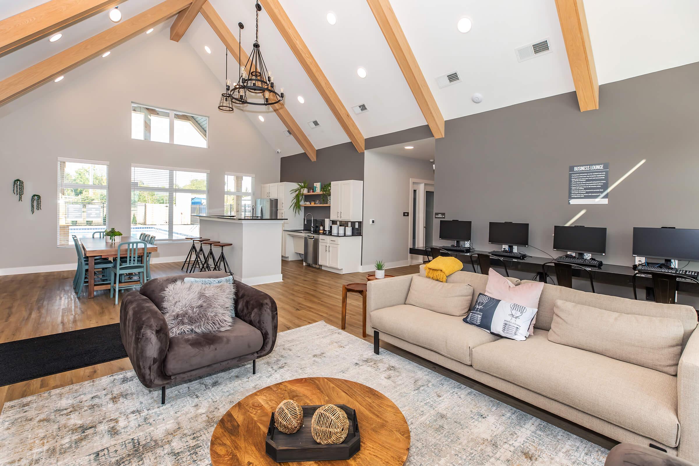 a living room filled with furniture and a large window