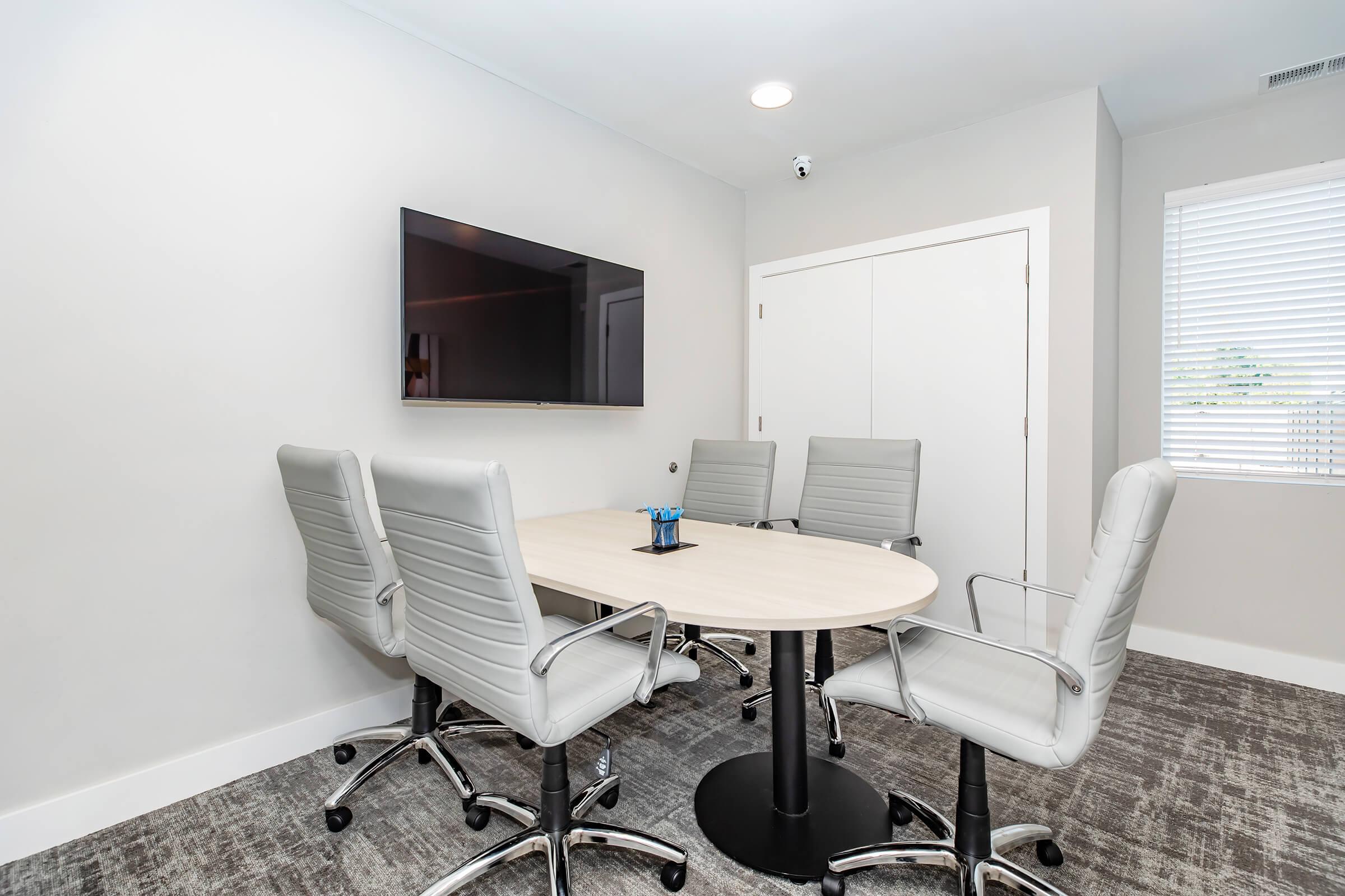 a living area with a desk and chair in a room