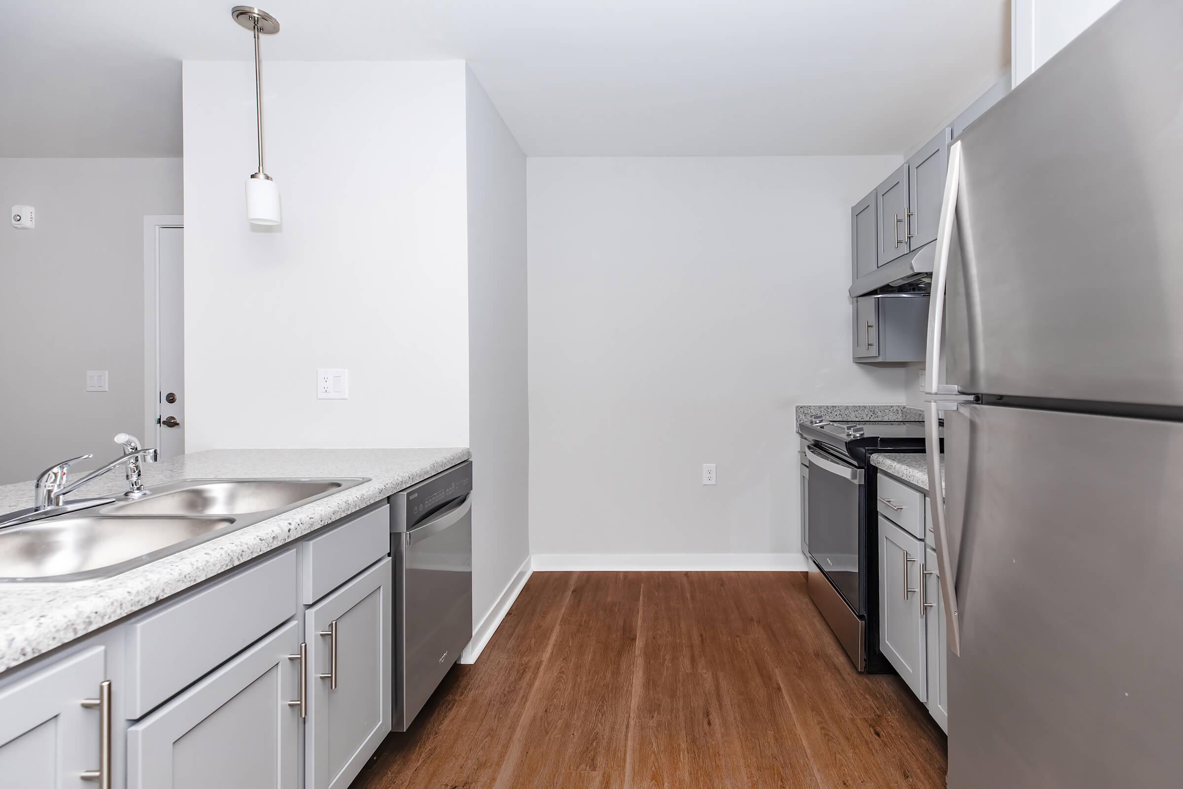 a kitchen with a stove and a refrigerator