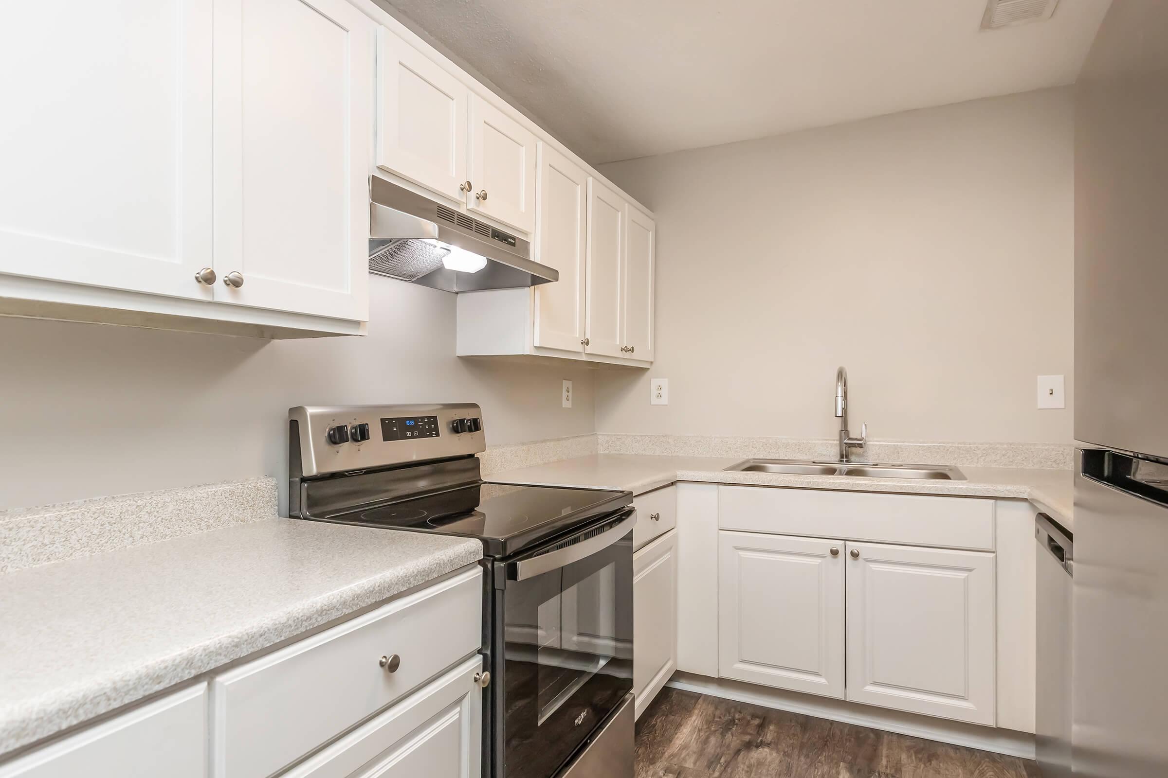 a kitchen with a stove a sink and a microwave