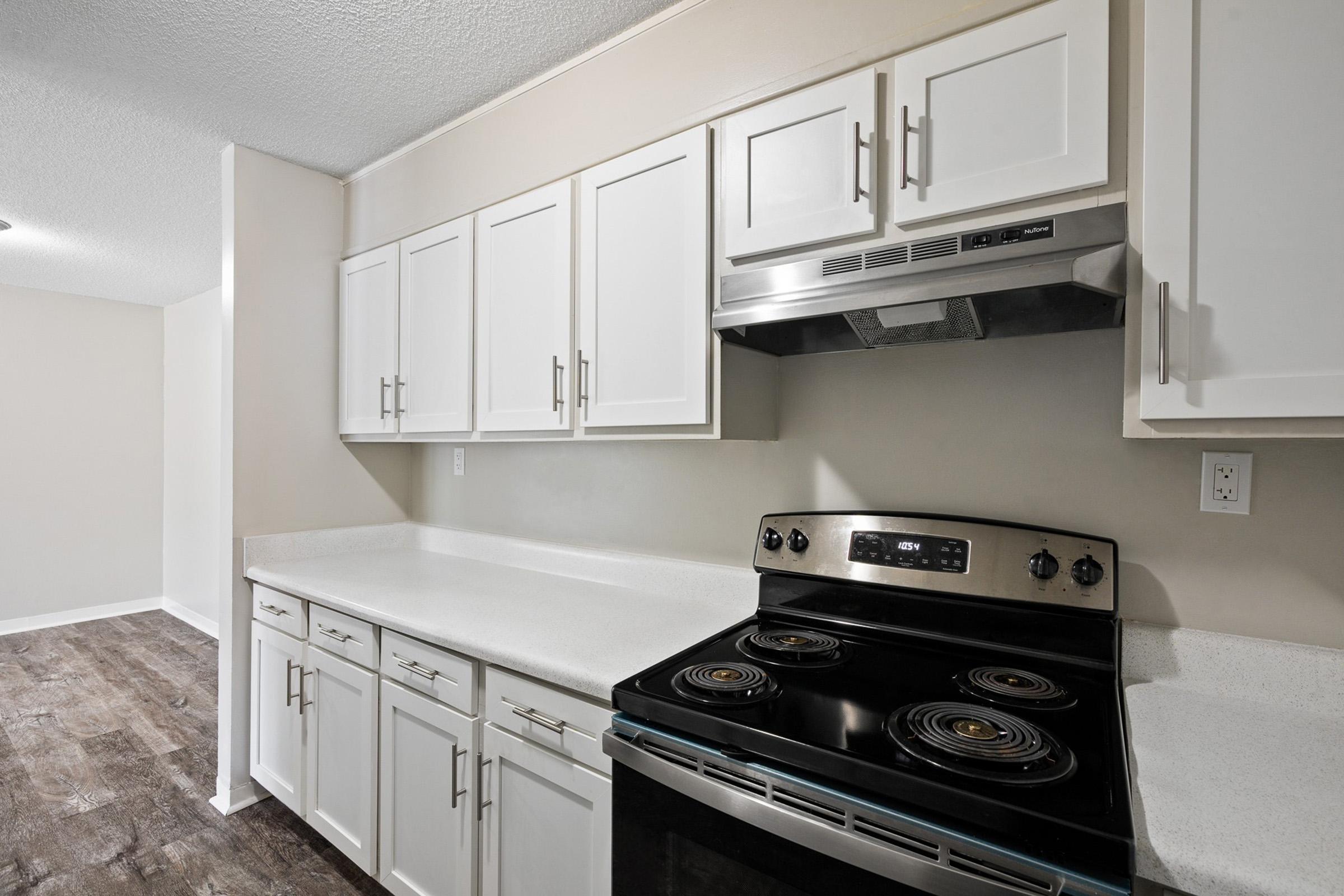 a stove top oven sitting inside of a kitchen