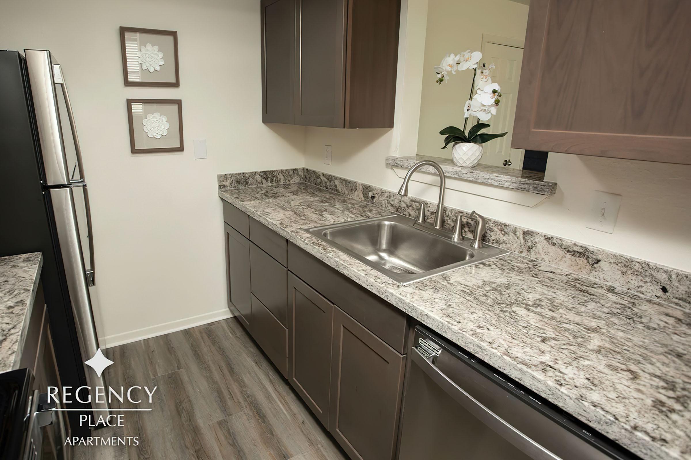 a kitchen with a sink and a mirror