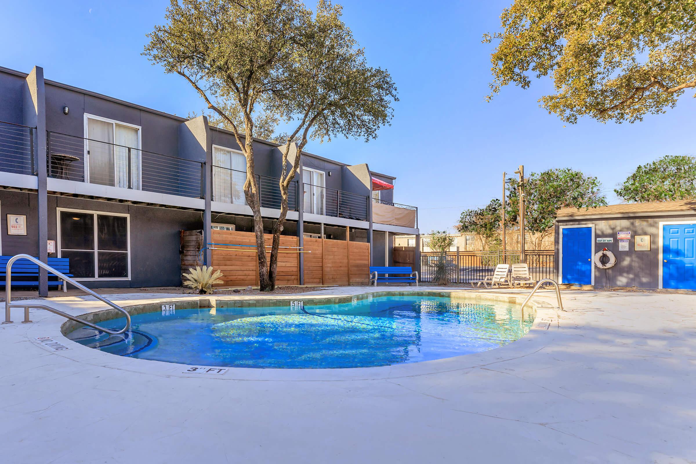 a blue pool of water in front of a house