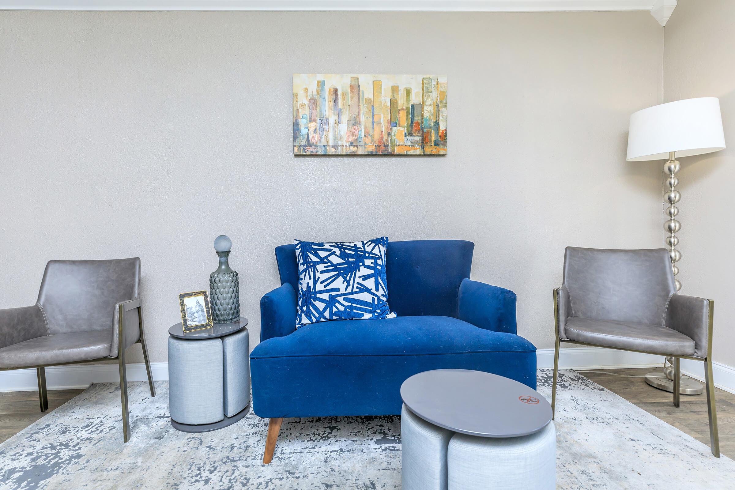 a living room filled with furniture and a blue chair