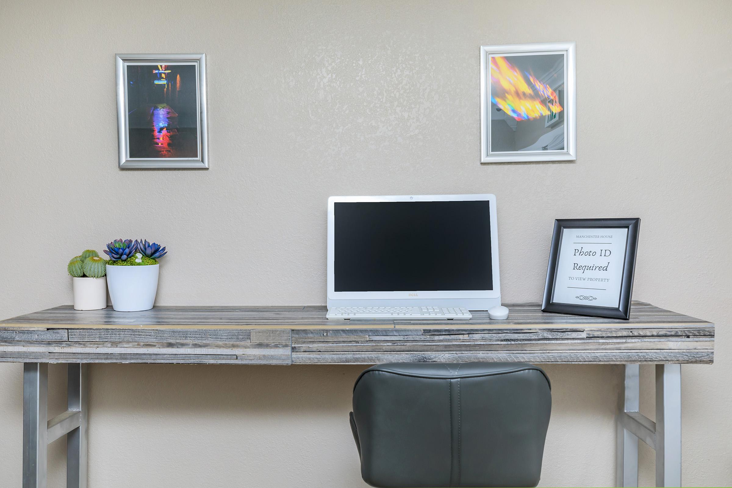 a desk with a computer on a table