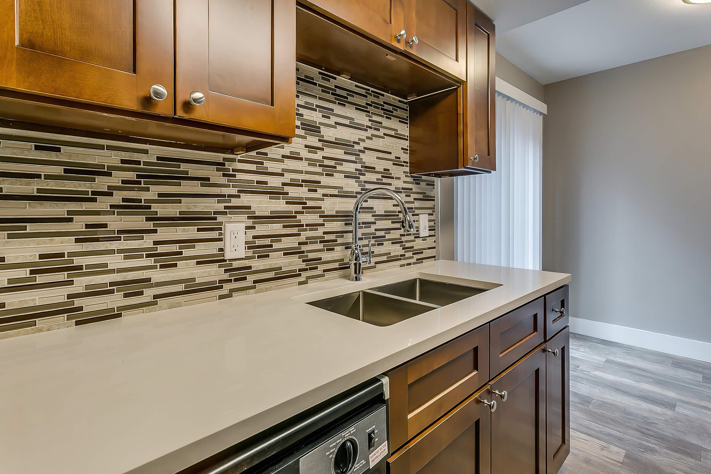 a kitchen with a sink and a mirror