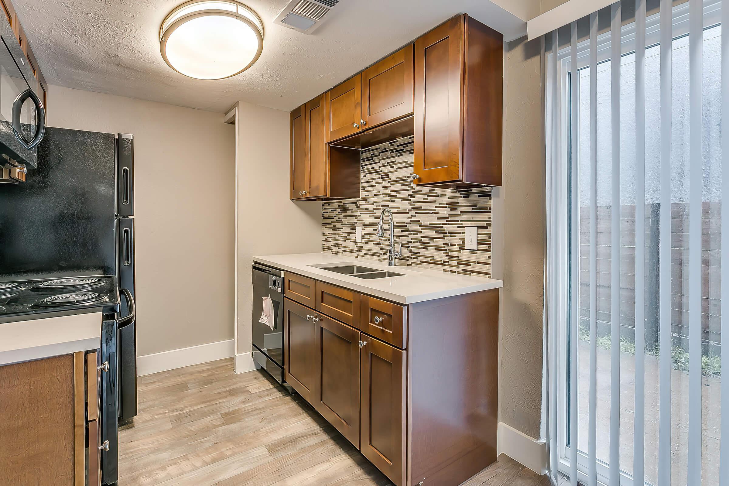 a kitchen with a stove top oven sitting inside of a room