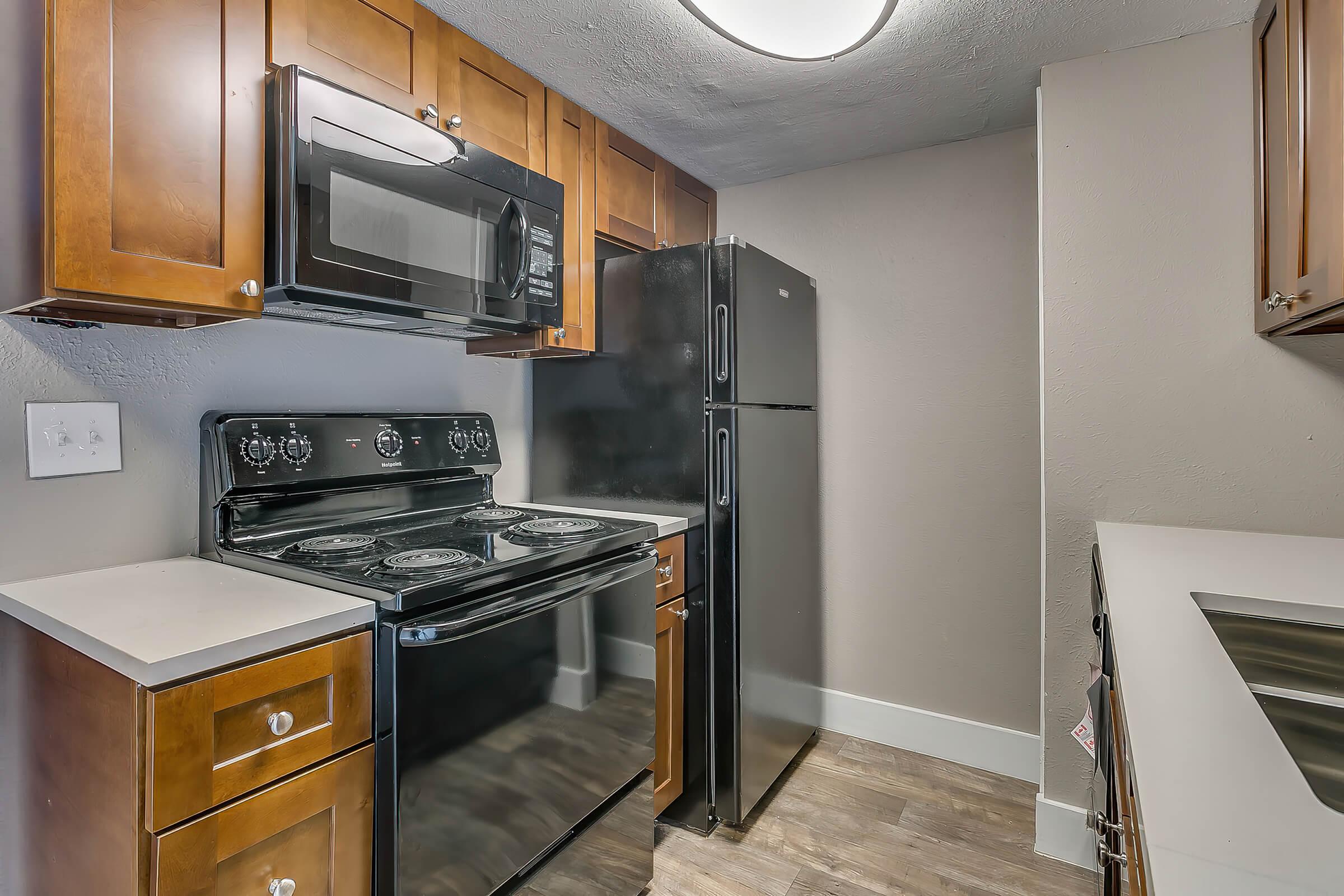 a stove top oven sitting inside of a kitchen