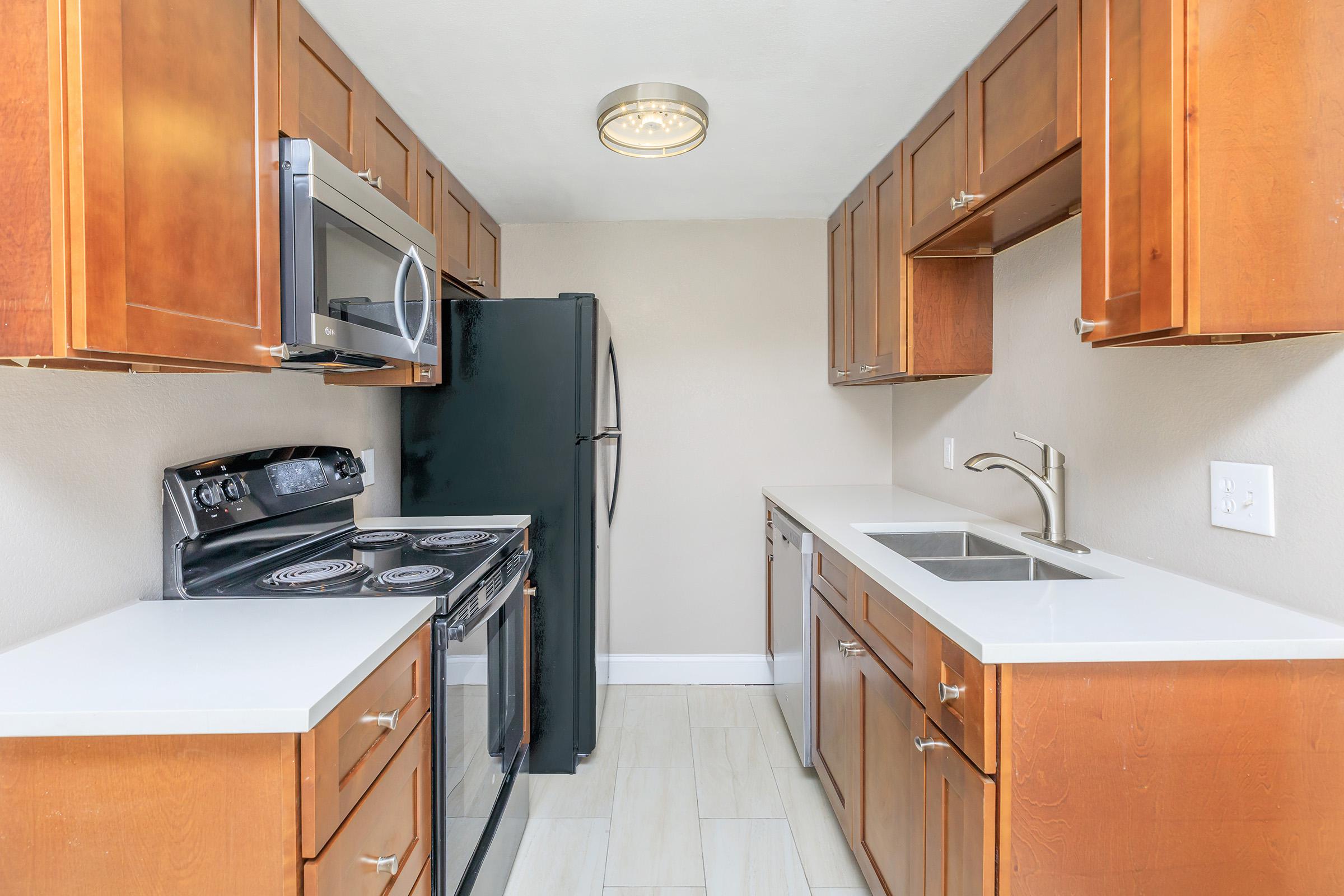 a kitchen with a stove and a refrigerator