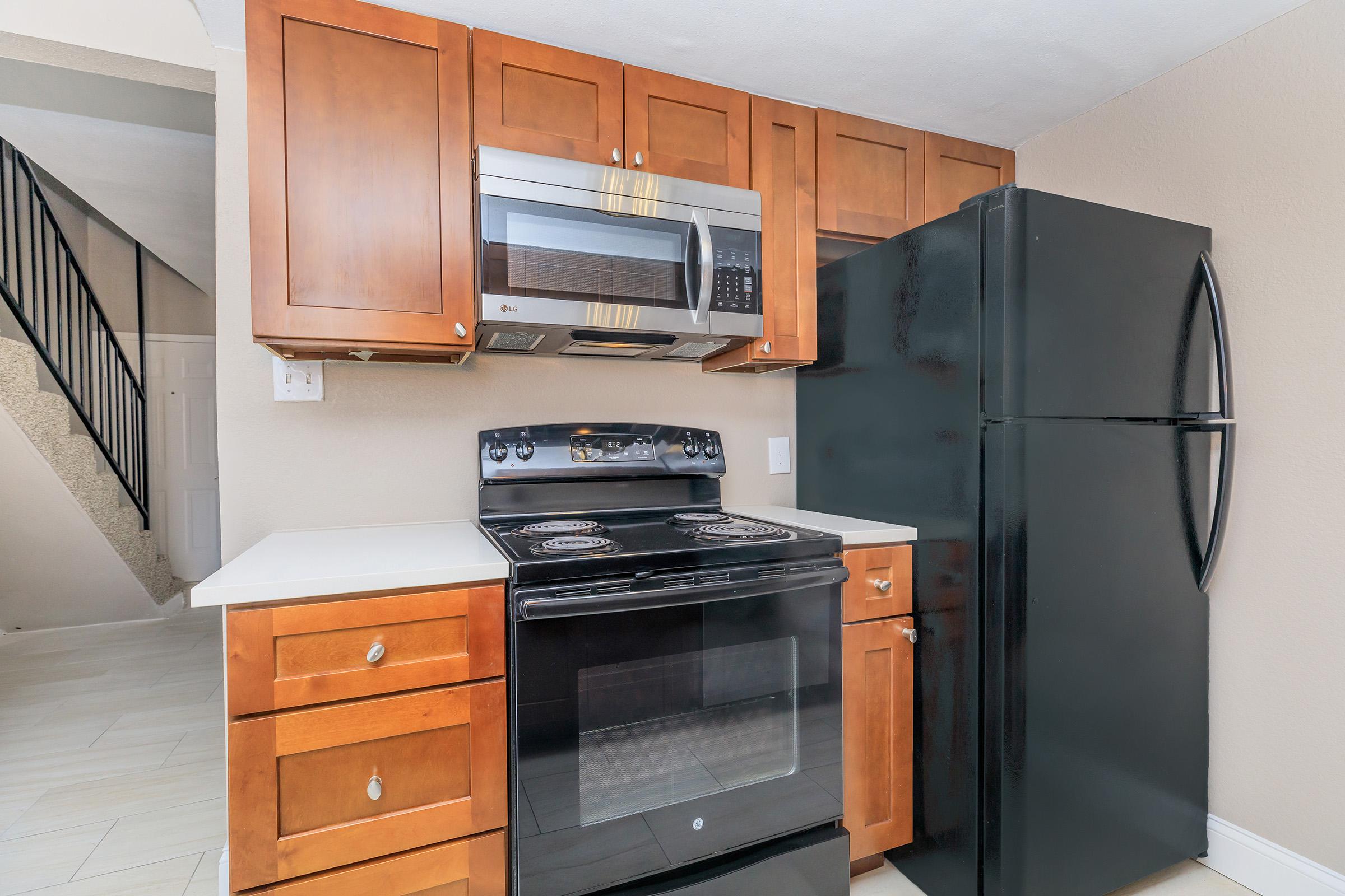 a stove top oven sitting inside of a kitchen