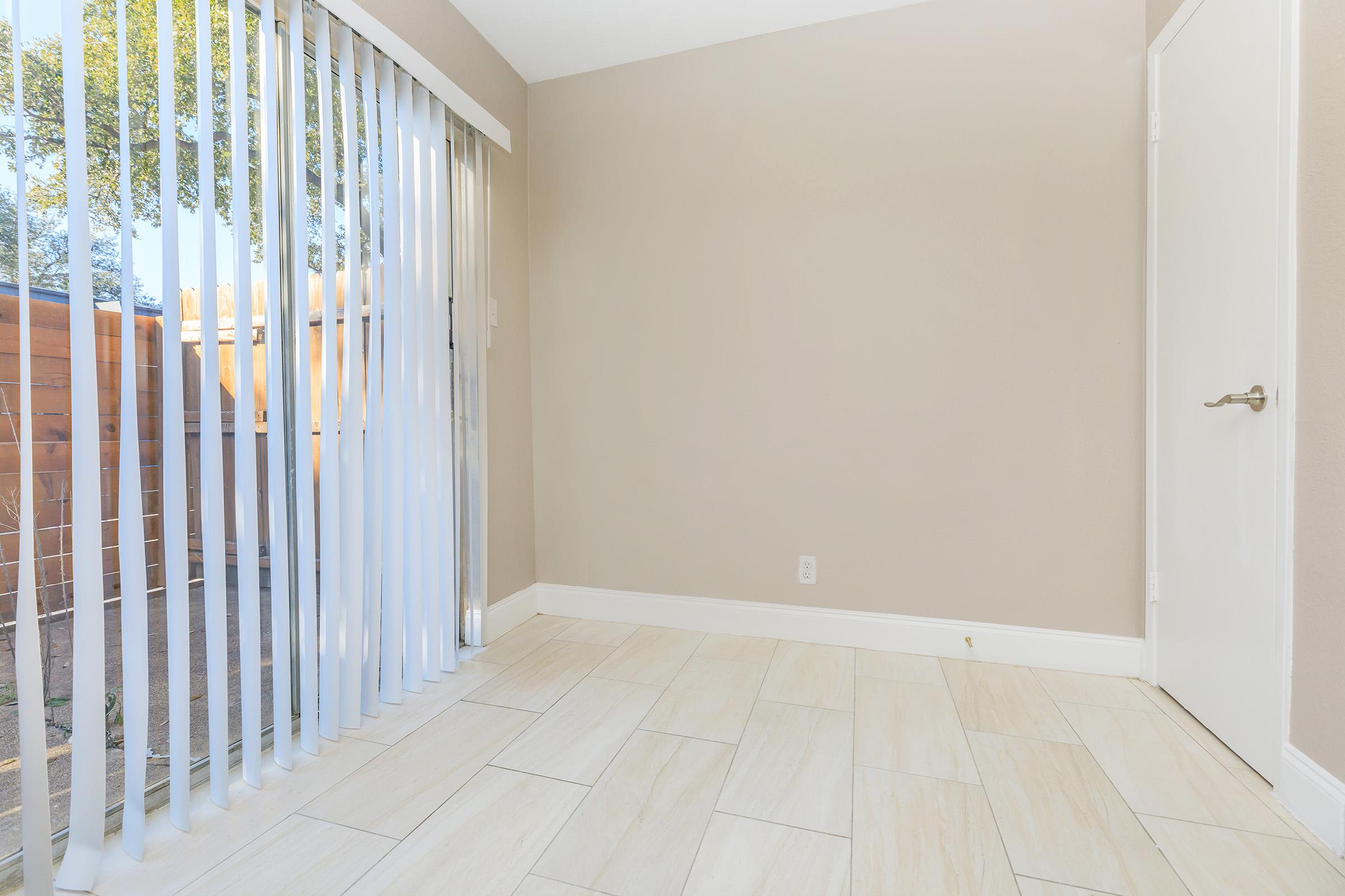 a bedroom with a building in the background