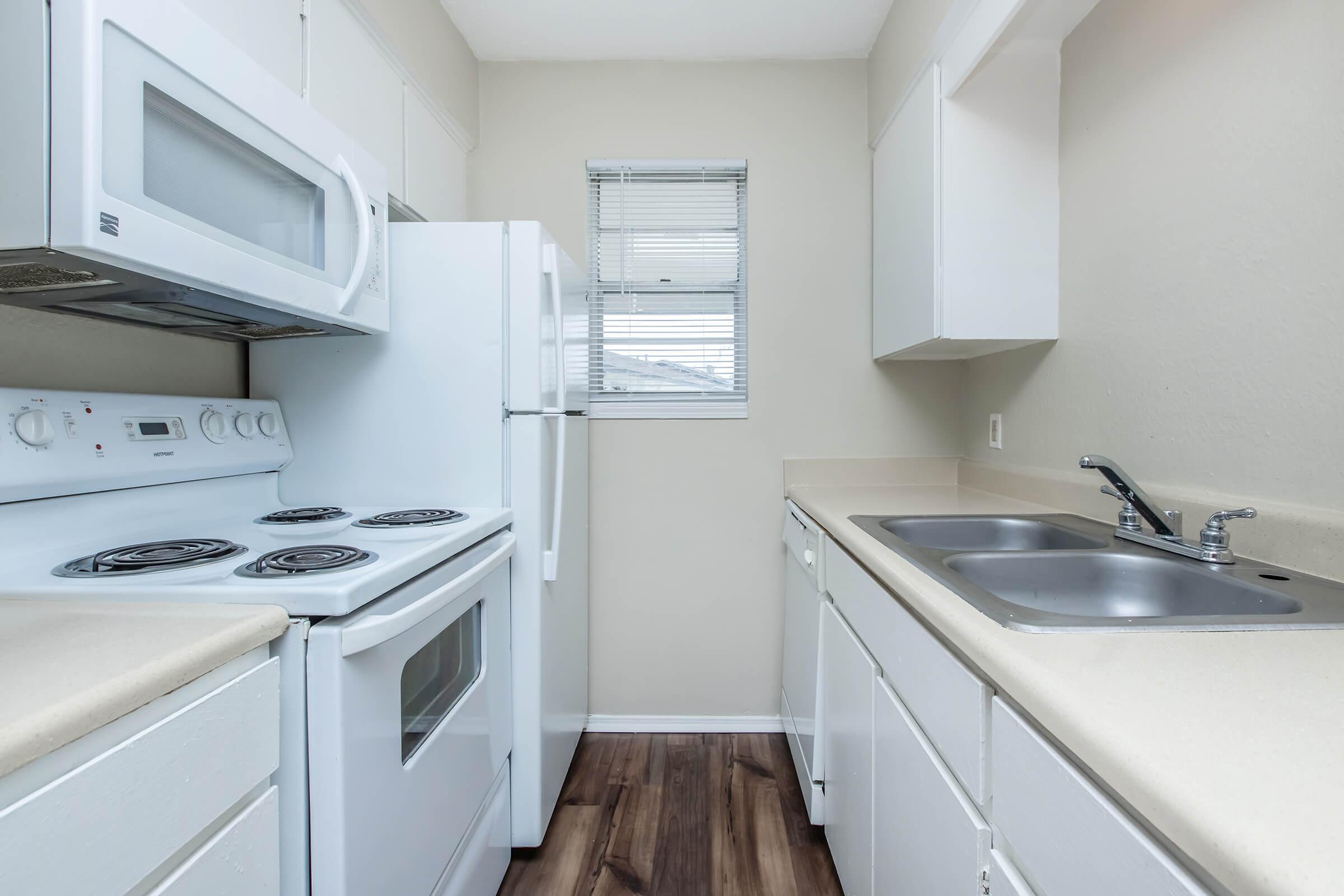 a kitchen with a stove and a sink