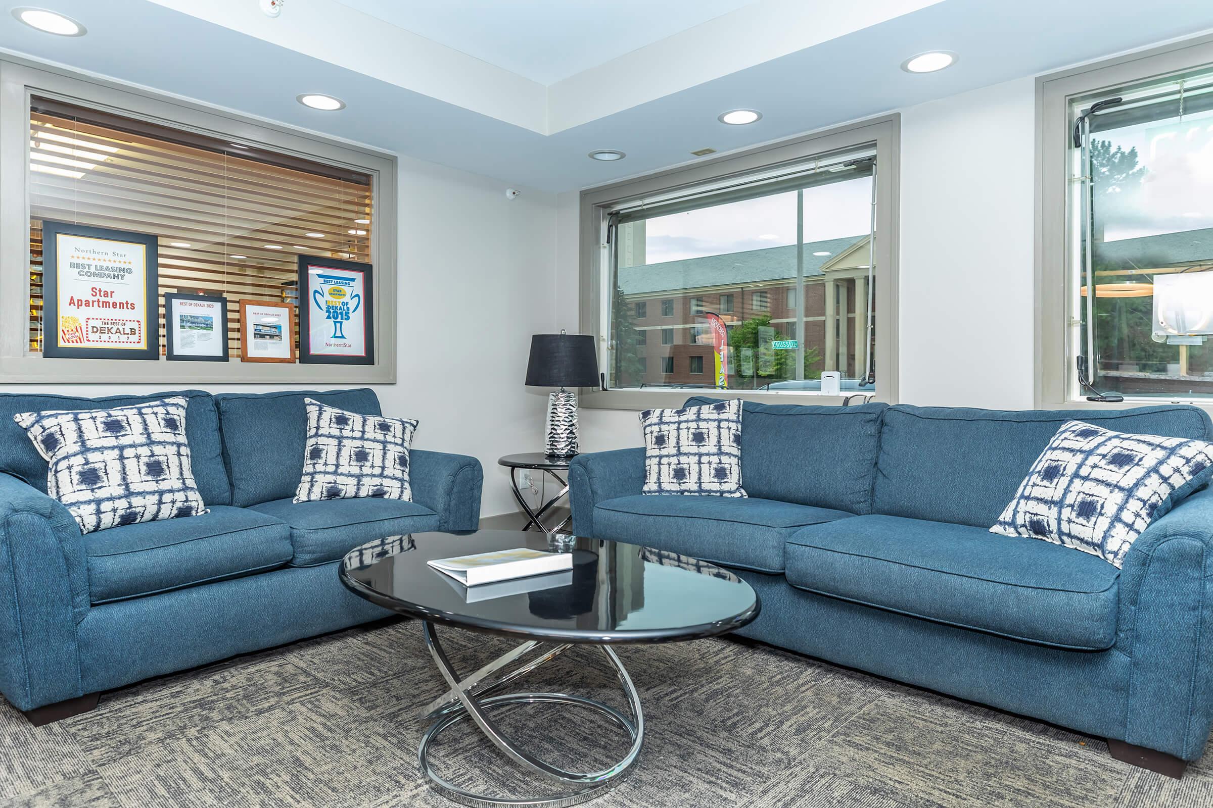 a living room filled with furniture and a large window